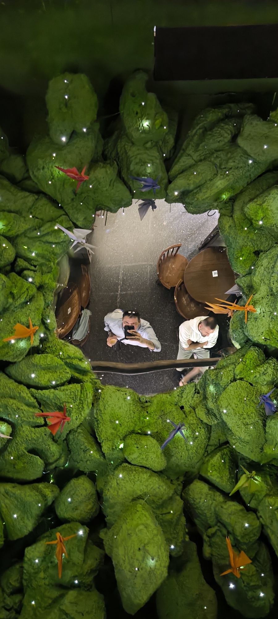Two diners reflected in decorative mirror at Barcelona restaurant