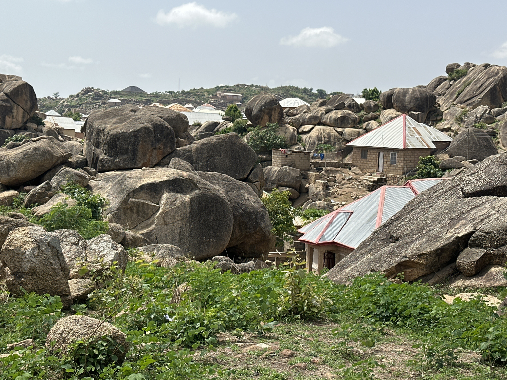 Jos Nigeria rocky landscape with granite boulders residential buildings documented