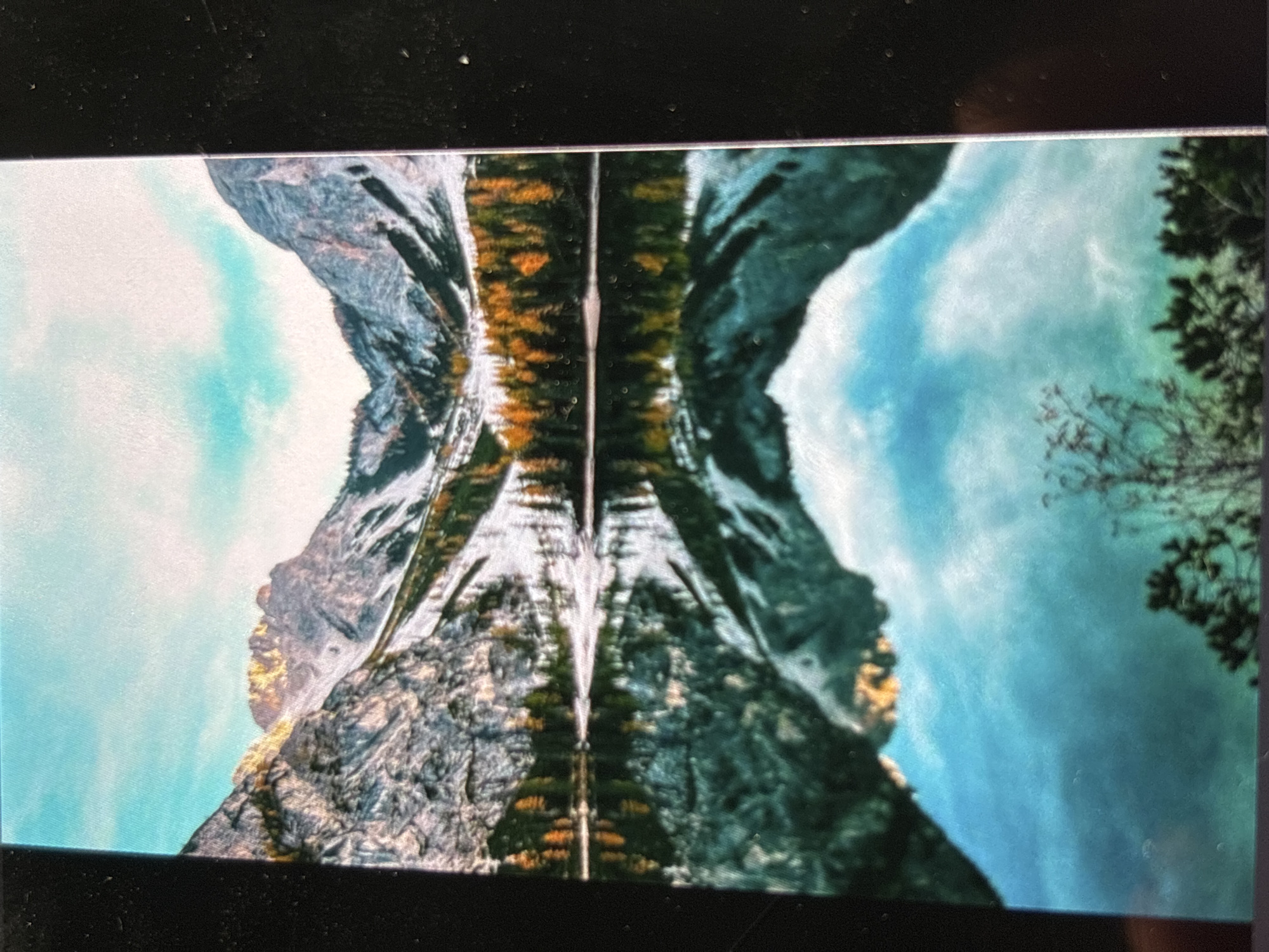 Witness captures symmetrical mountain landscape with rock formations