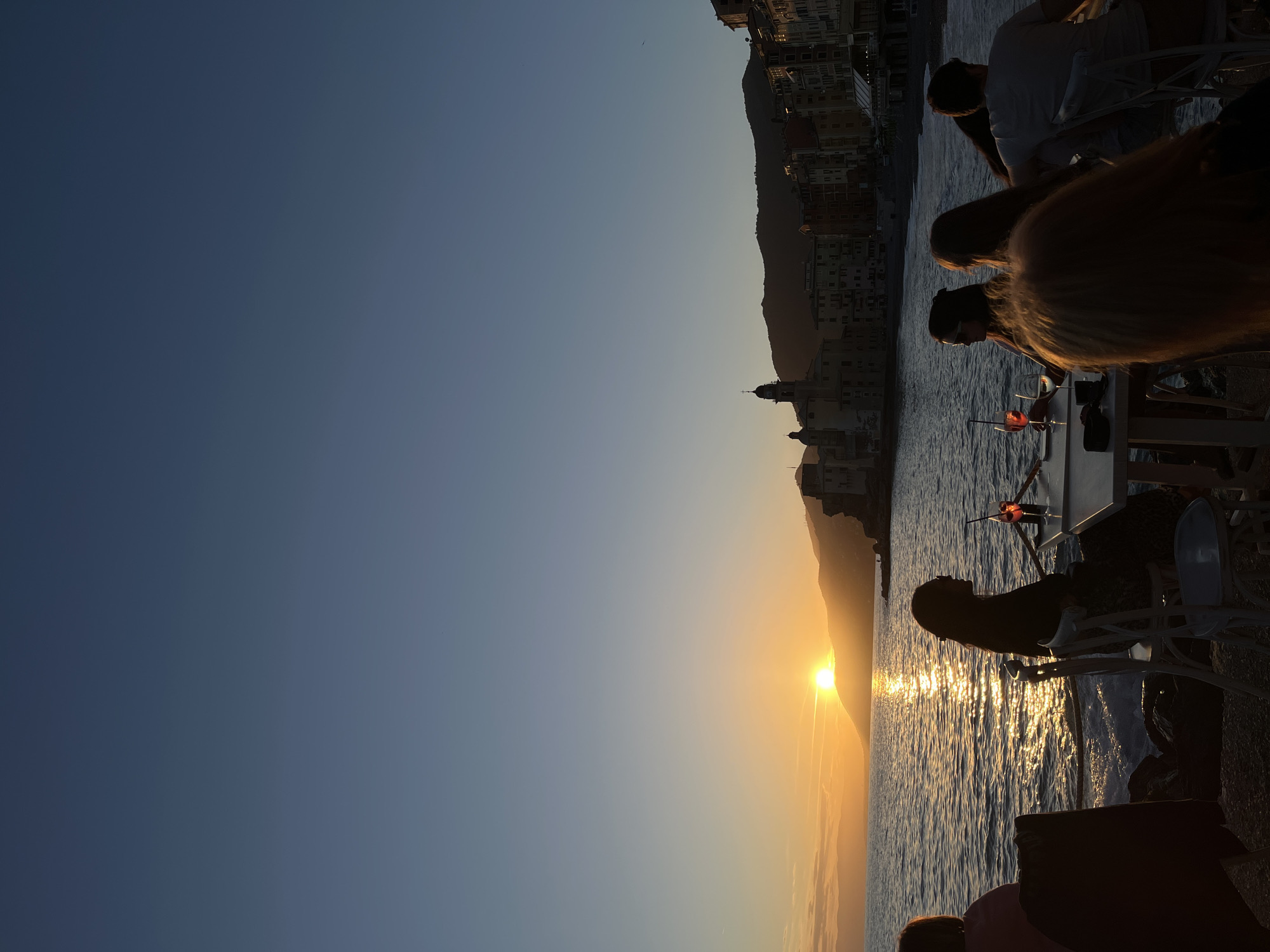 Sunset dining captured at Camogli waterfront, Italy