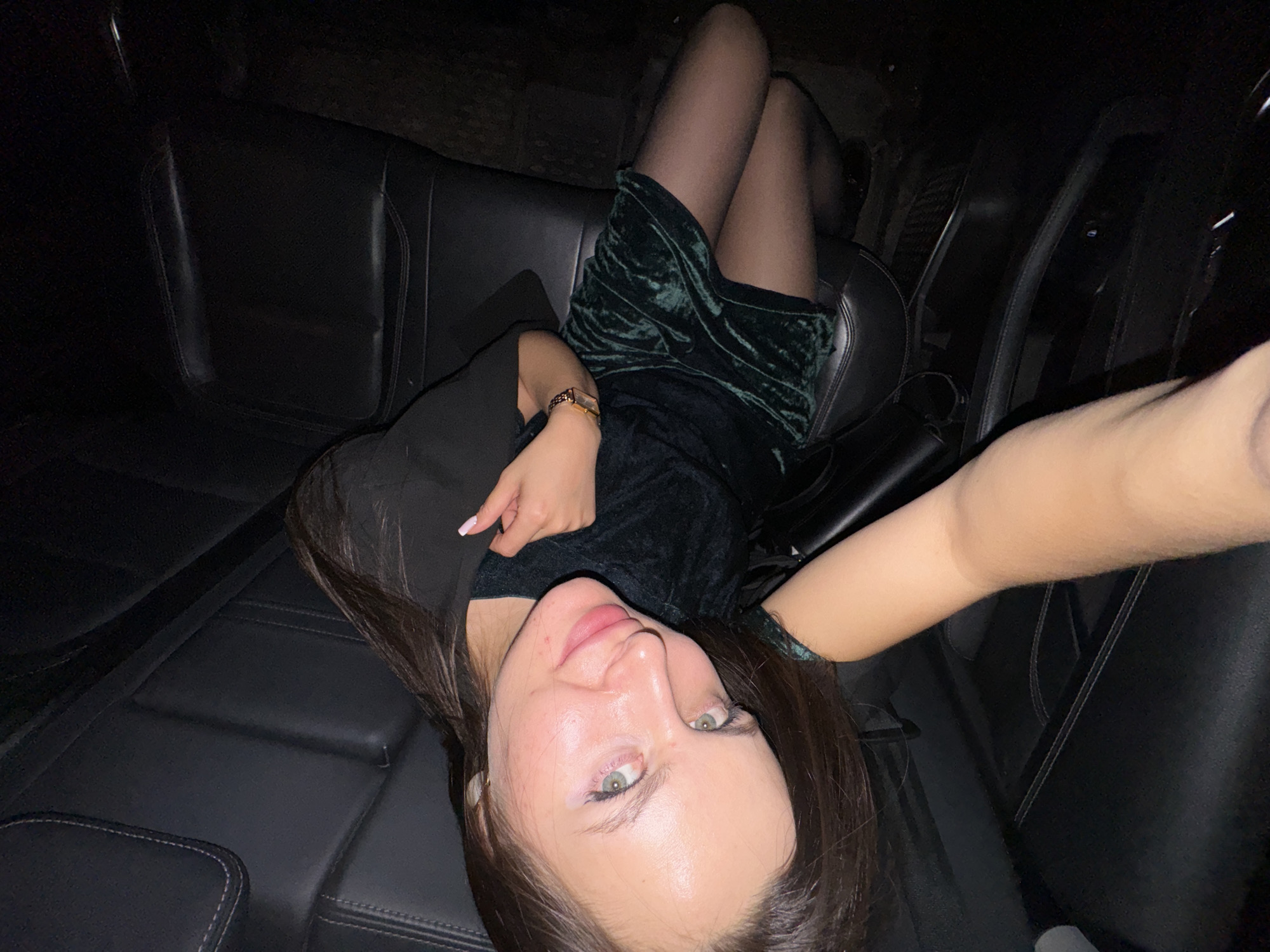 Woman in green dress observed in car backseat, Odintsovo