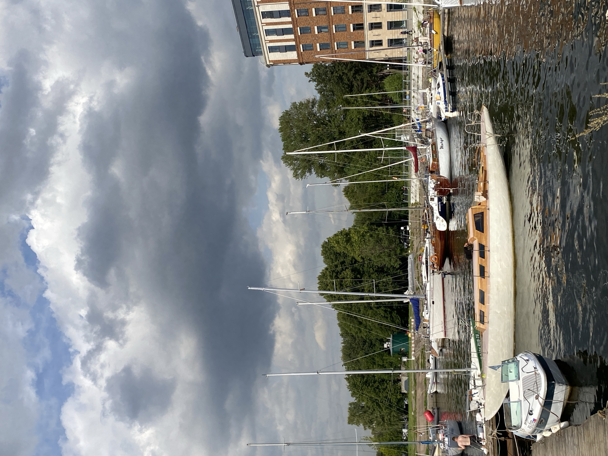 Saint Petersburg marina: sailboats, a crane lift, and river traffic