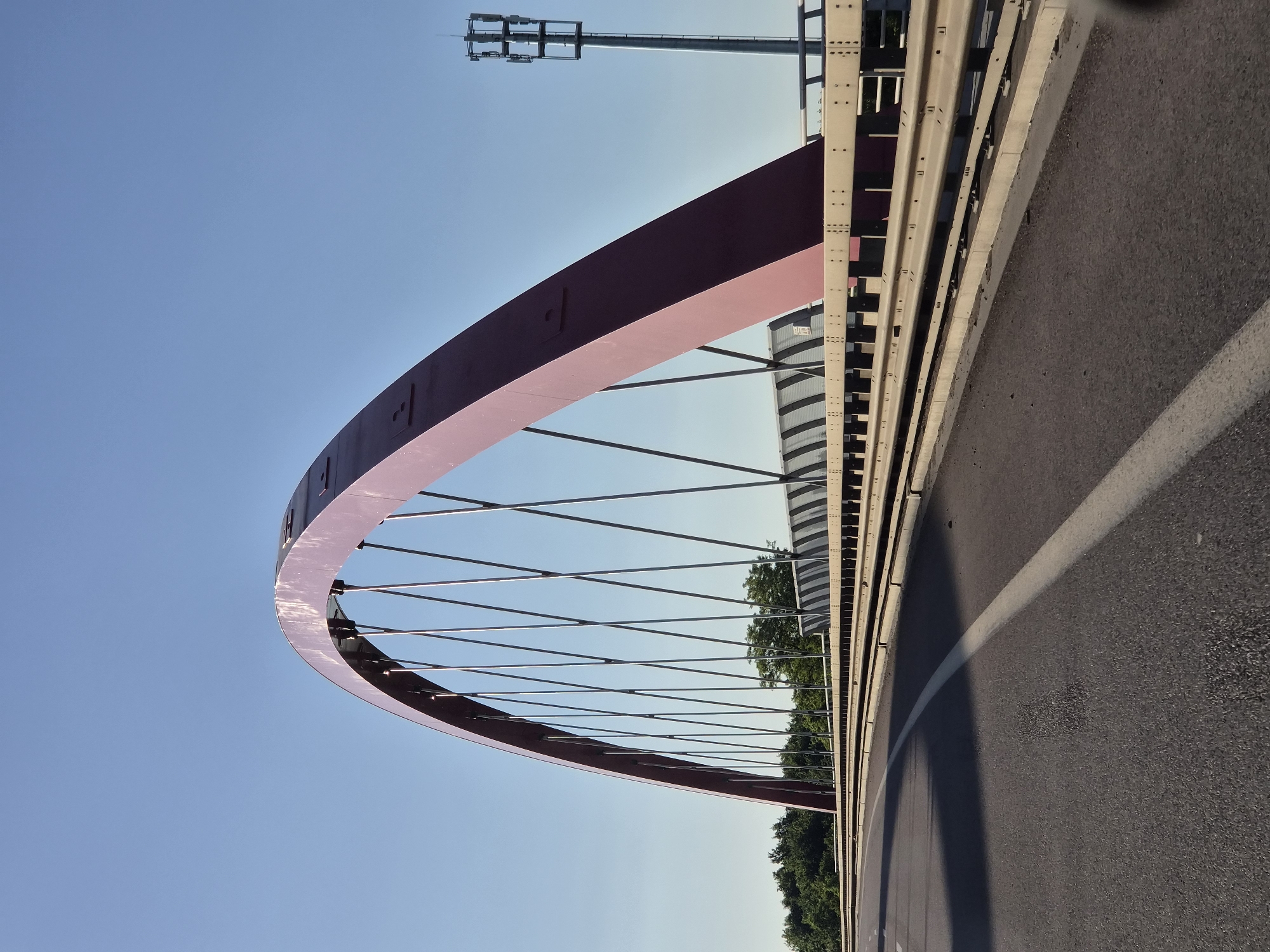 Clear skies frame Pont Rouge bridge in Schifflange