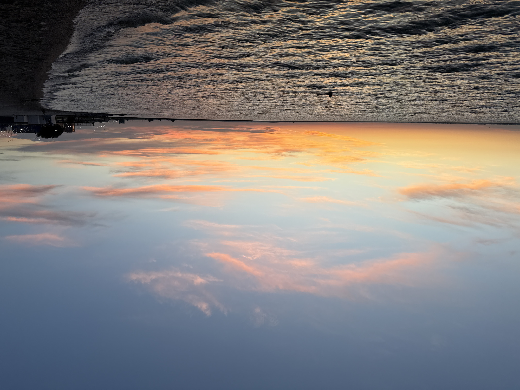 Quiet sunset over a still shoreline in Kokshetau