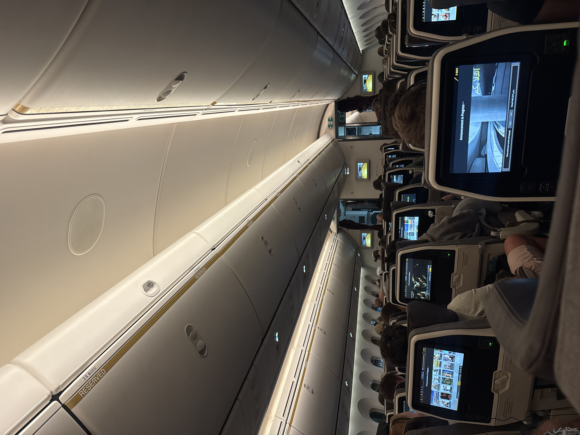 Aircraft cabin interior observed with active entertainment systems, Mai Khao