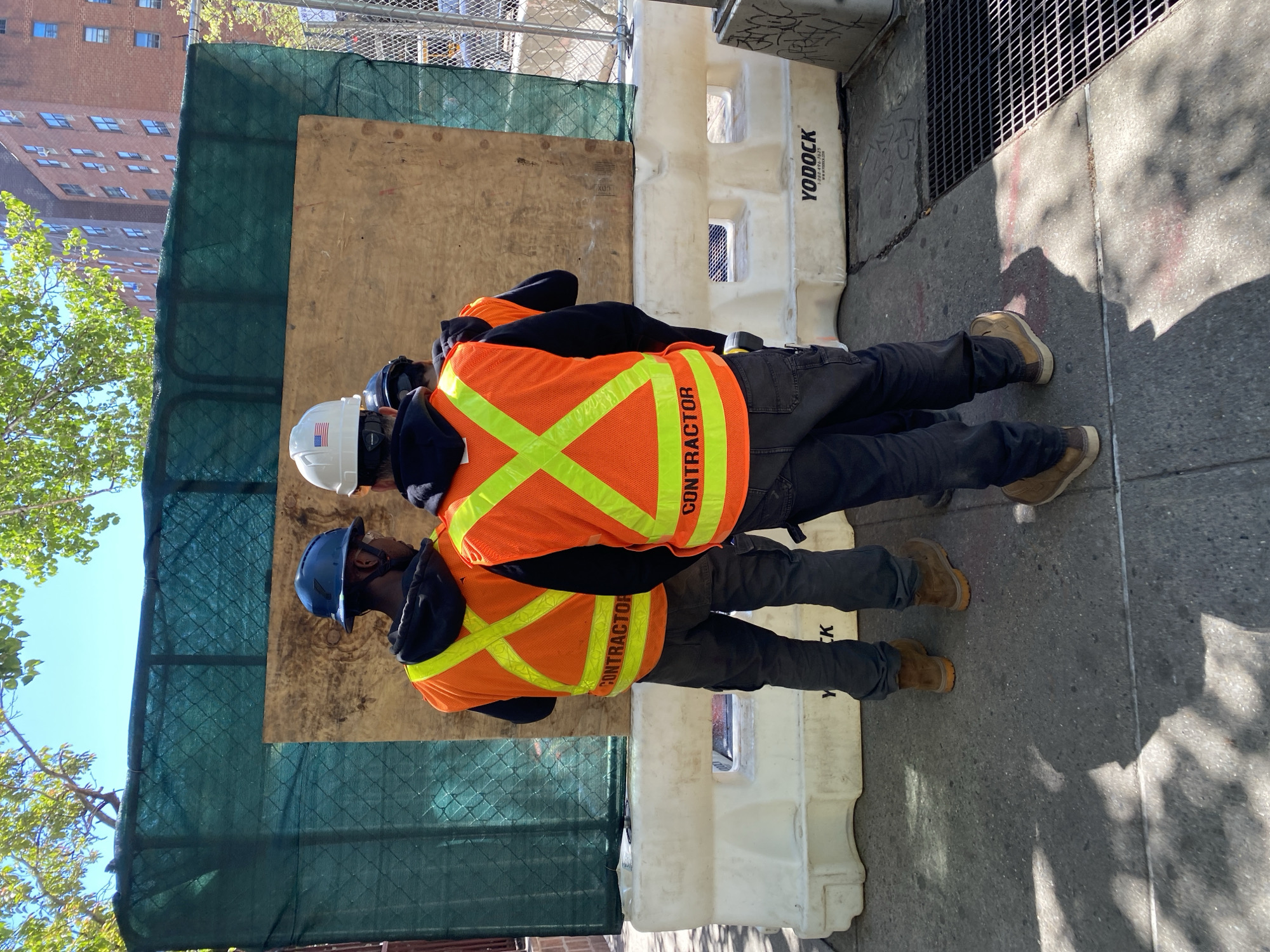 Construction workers spotted on NYC sidewalk wearing safety gear