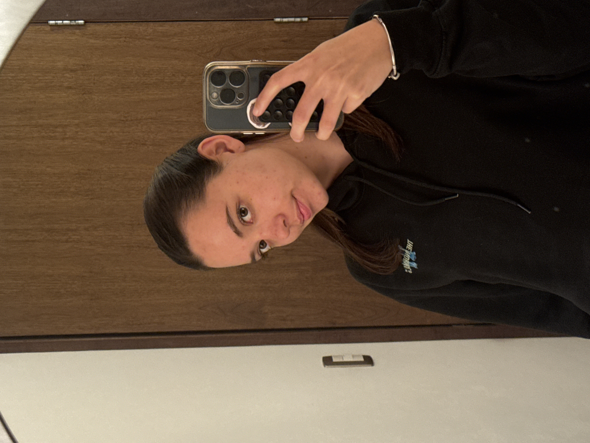 Woman takes mirror selfie in Mexican town early morning