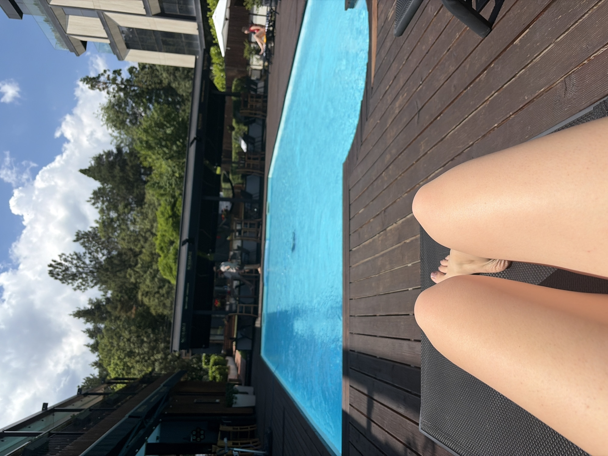 Woman sunbathes poolside in Sofia