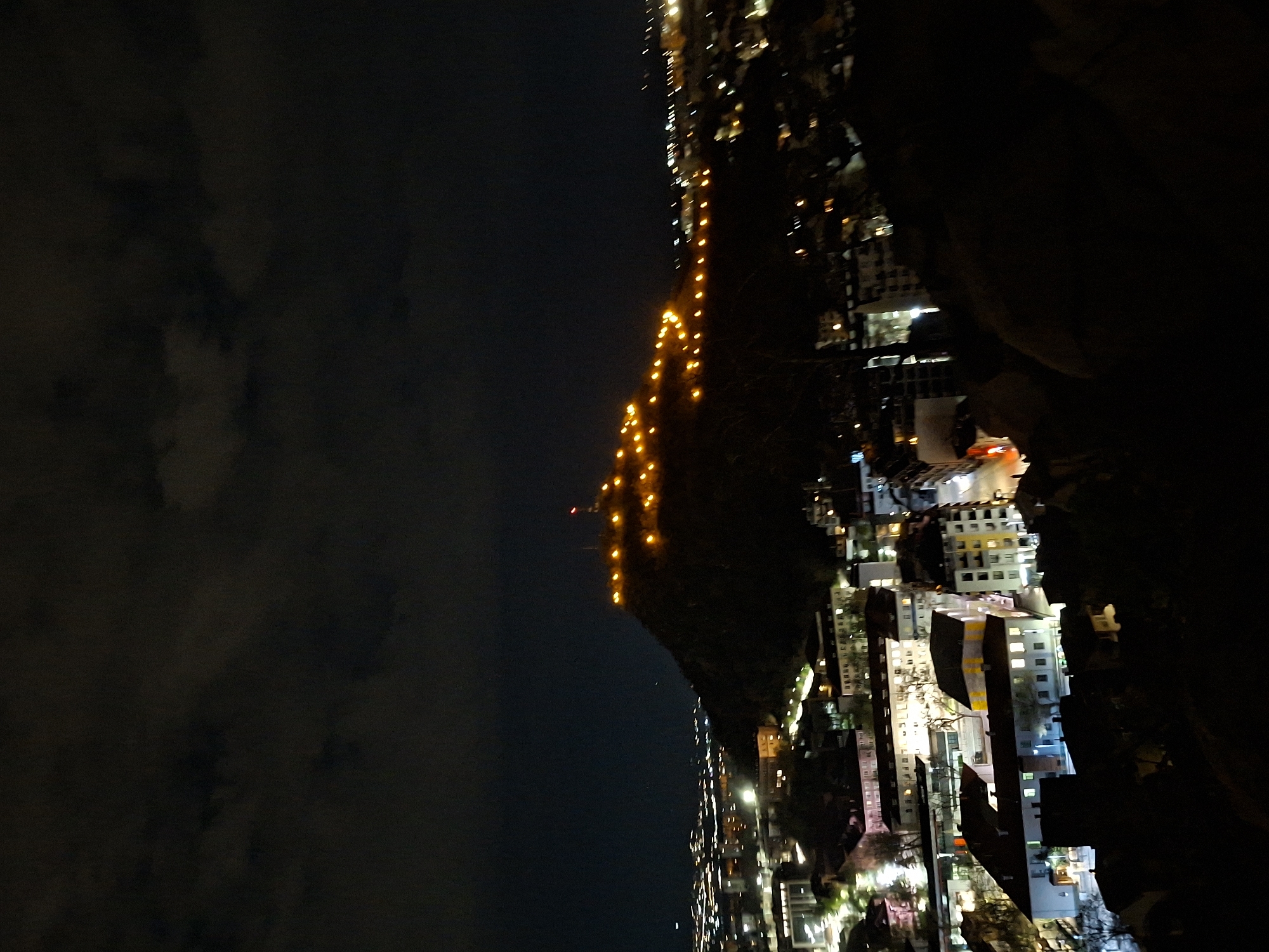 Plovdiv's illuminated hillside captured in nighttime cityscape view
