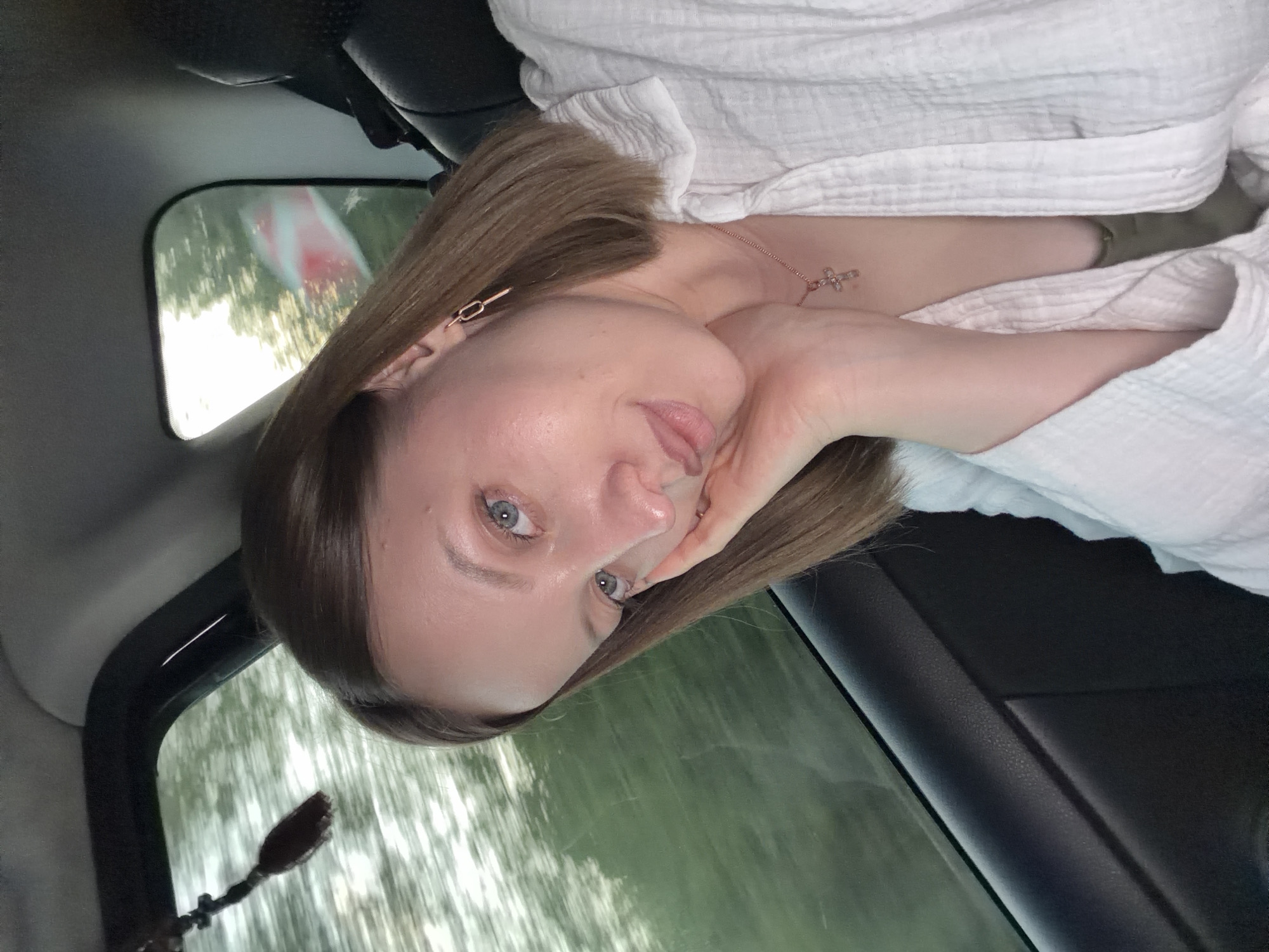 Woman takes selfie in car passenger seat in Russia