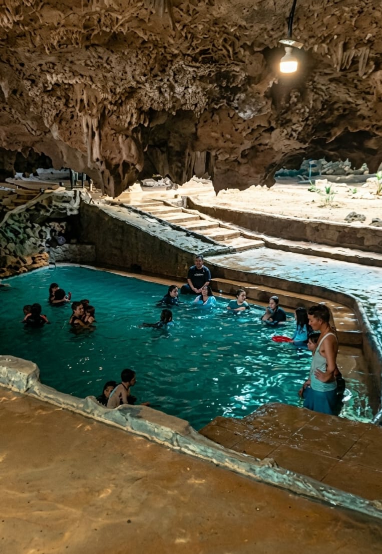 Swimming in a turquoise cave pool in Penungkiren, Indonesia