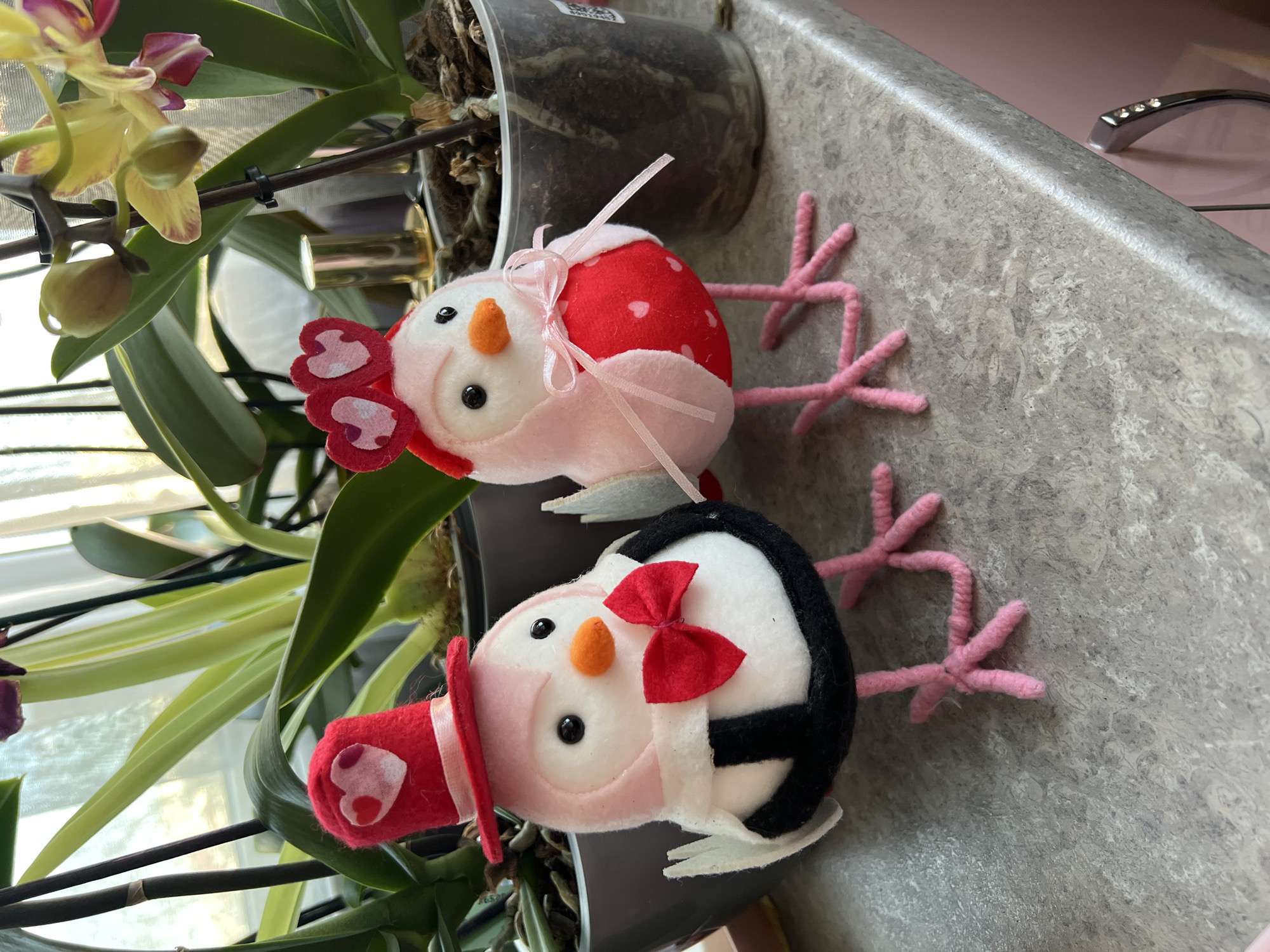 Decorative stuffed birds displayed with orchid in Ruse home