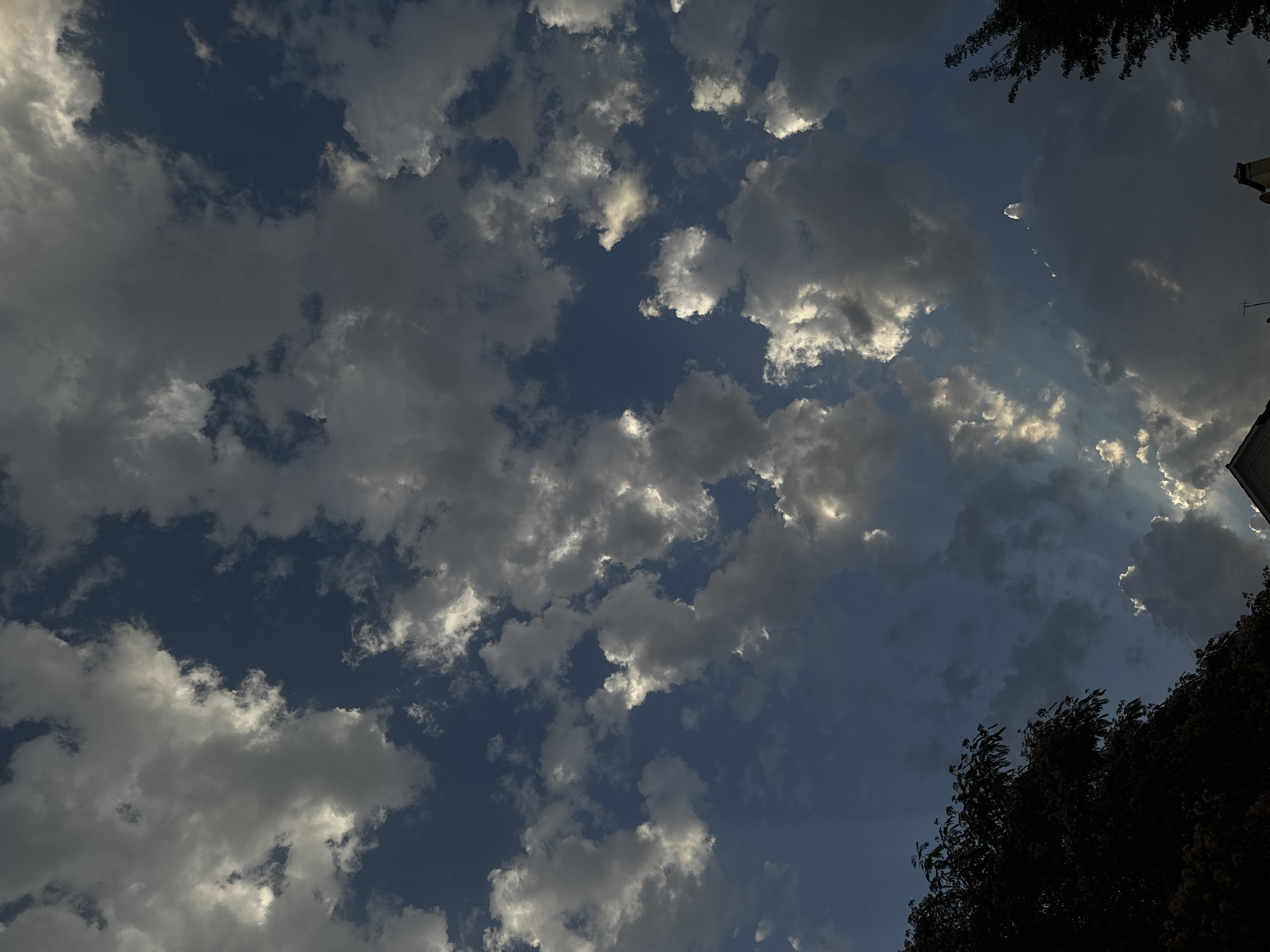 Sunlit cumulus clouds and crepuscular rays over Tashkent
