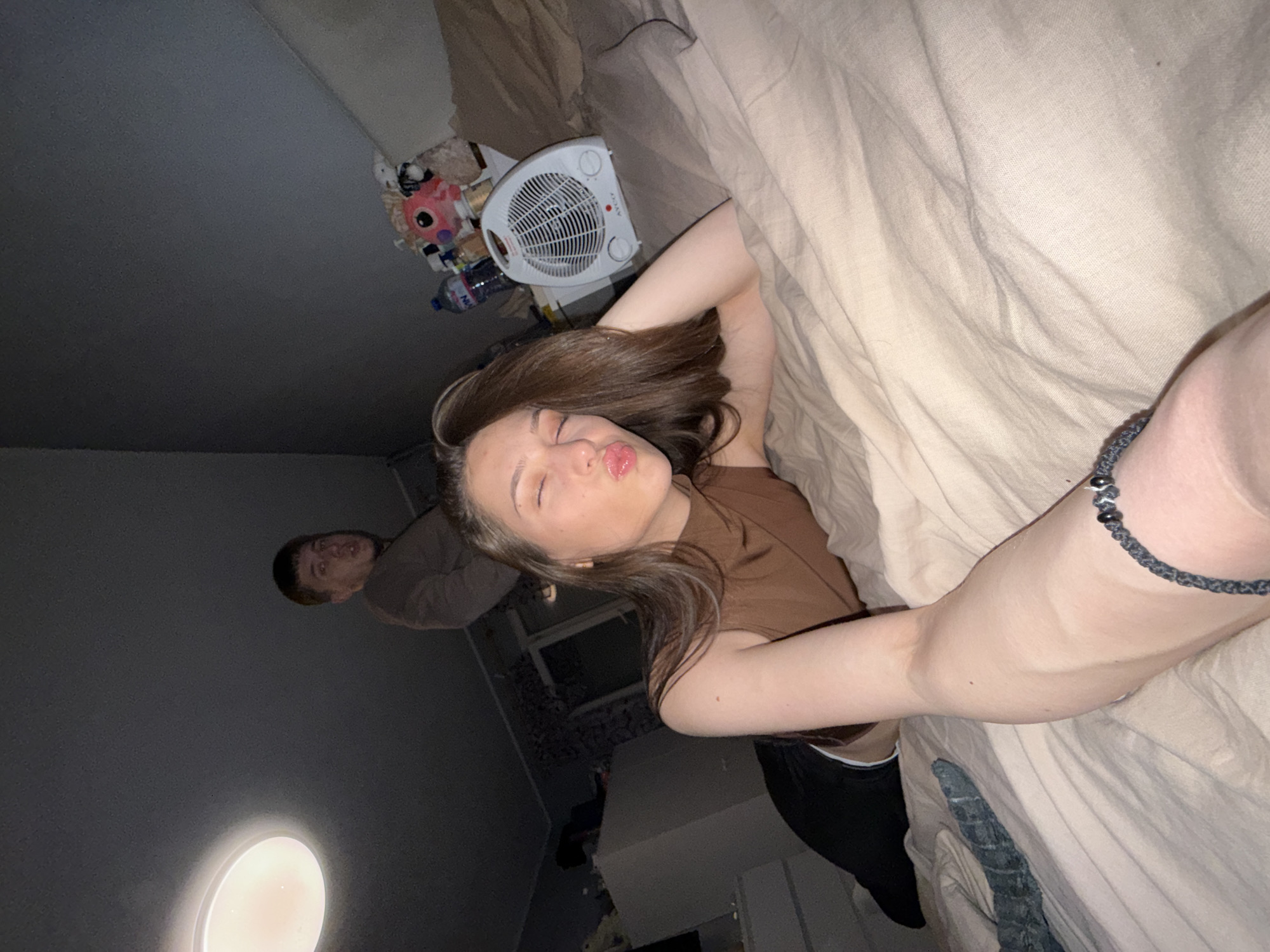 Young people gather in Sofia bedroom, smartphones present