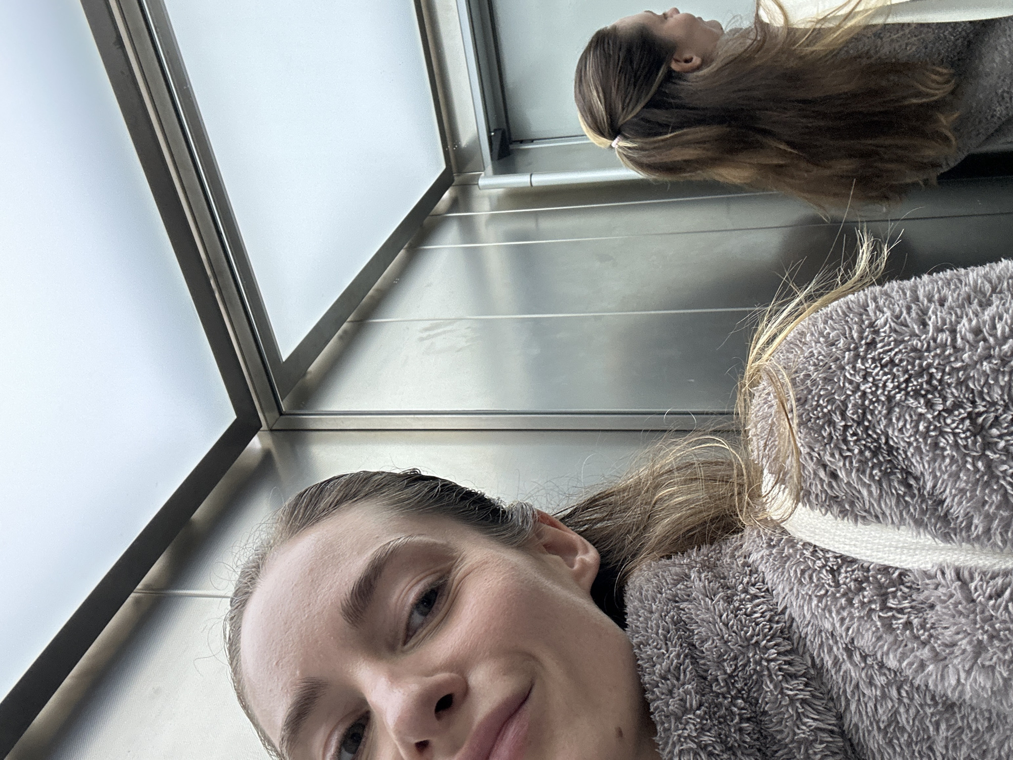 Woman documents morning coffee routine in Kiel elevator selfies