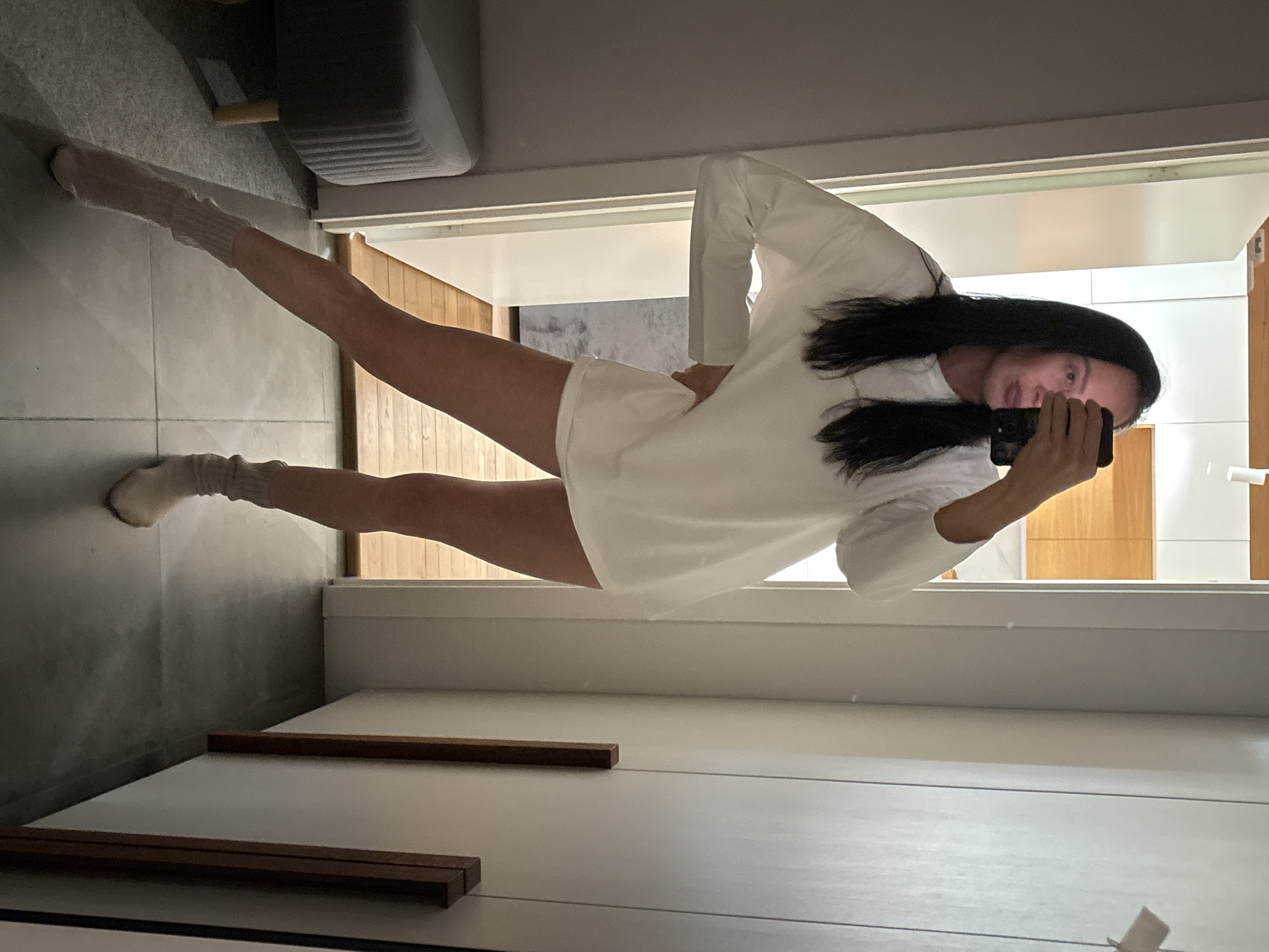 Woman takes bathroom mirror selfie in Chaikovsky, Russia