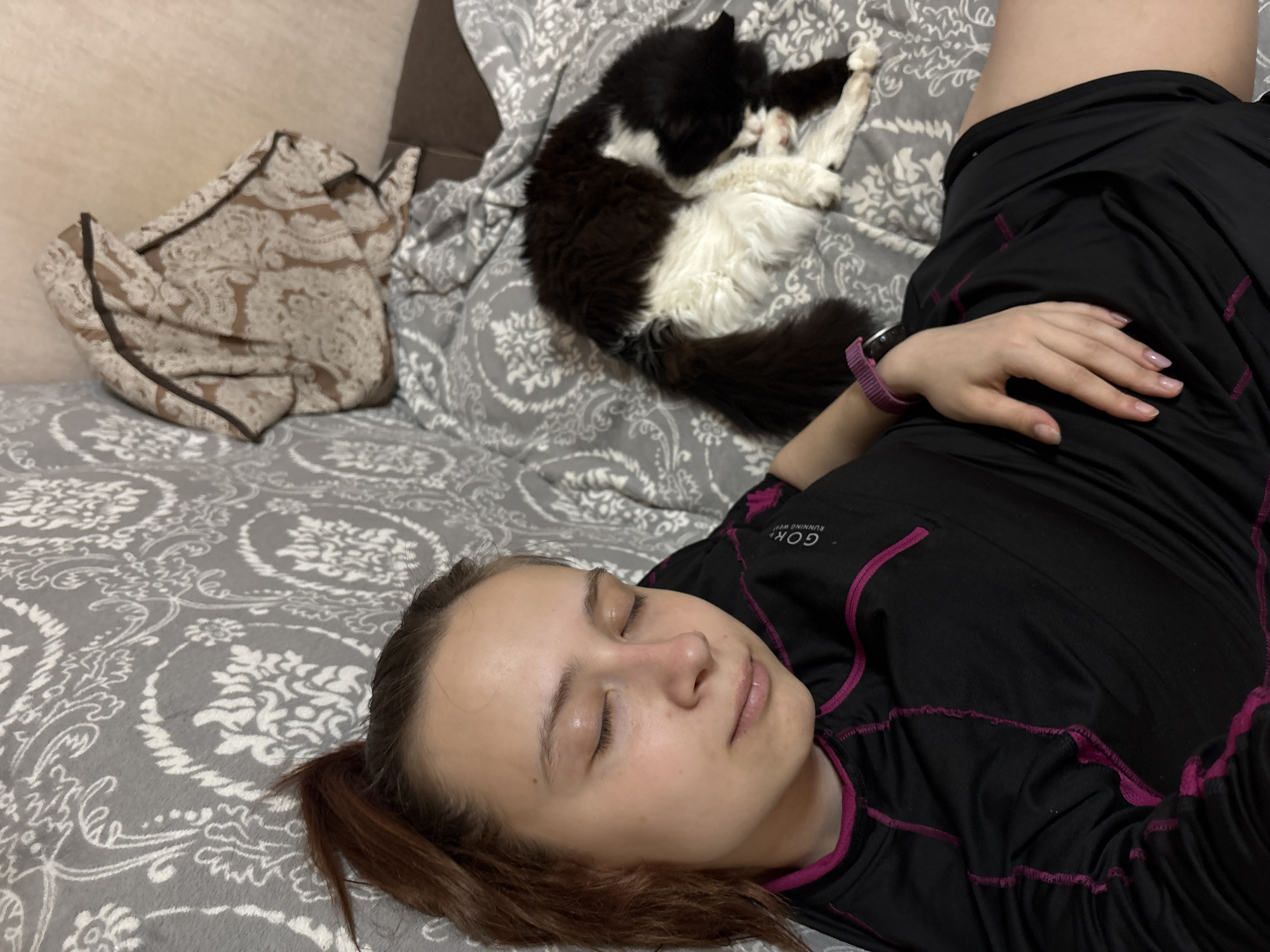 Woman and cat sleep peacefully in Russian home