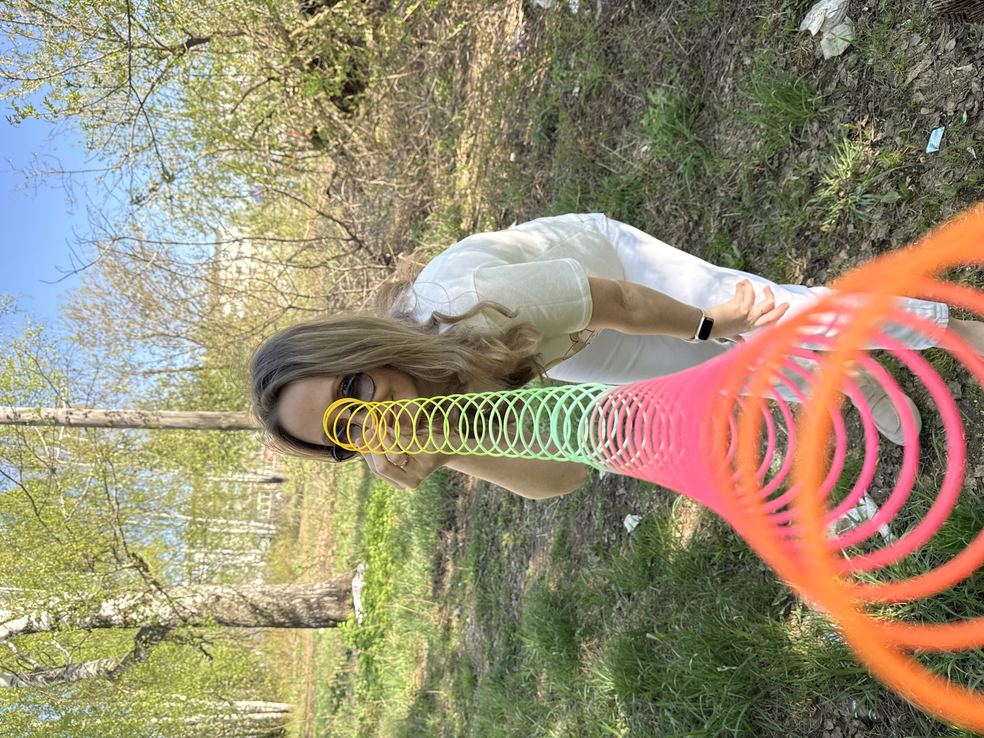Woman enjoys spring afternoon with slinky in Chaikovsky park