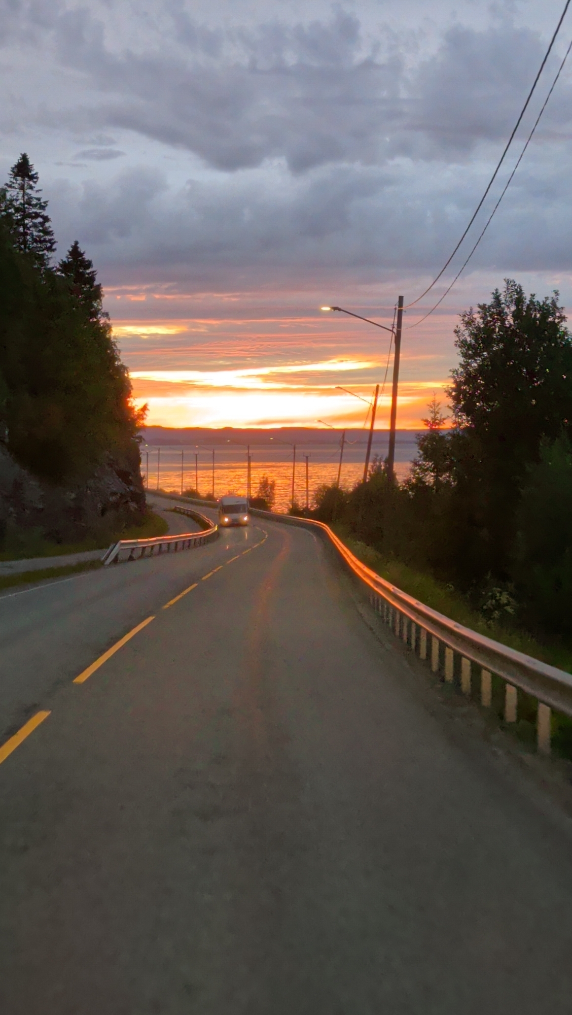 Sunset light over a winding coastal road in Hommelvik, Norway