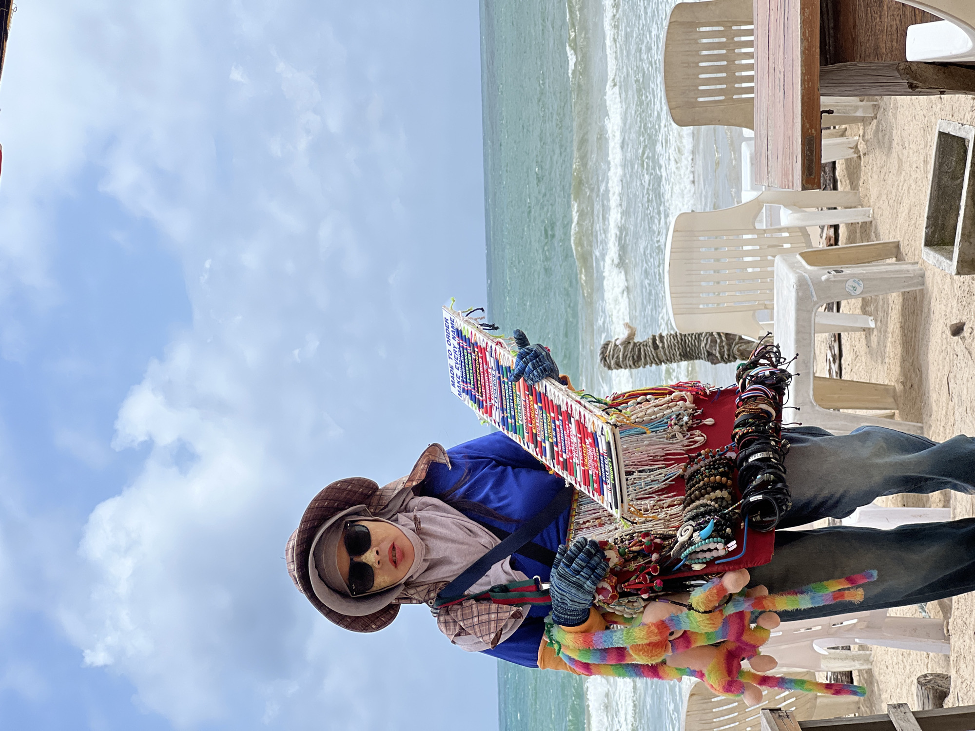 Beach scene documented: vendor, furniture, warning flag, wildlife observed