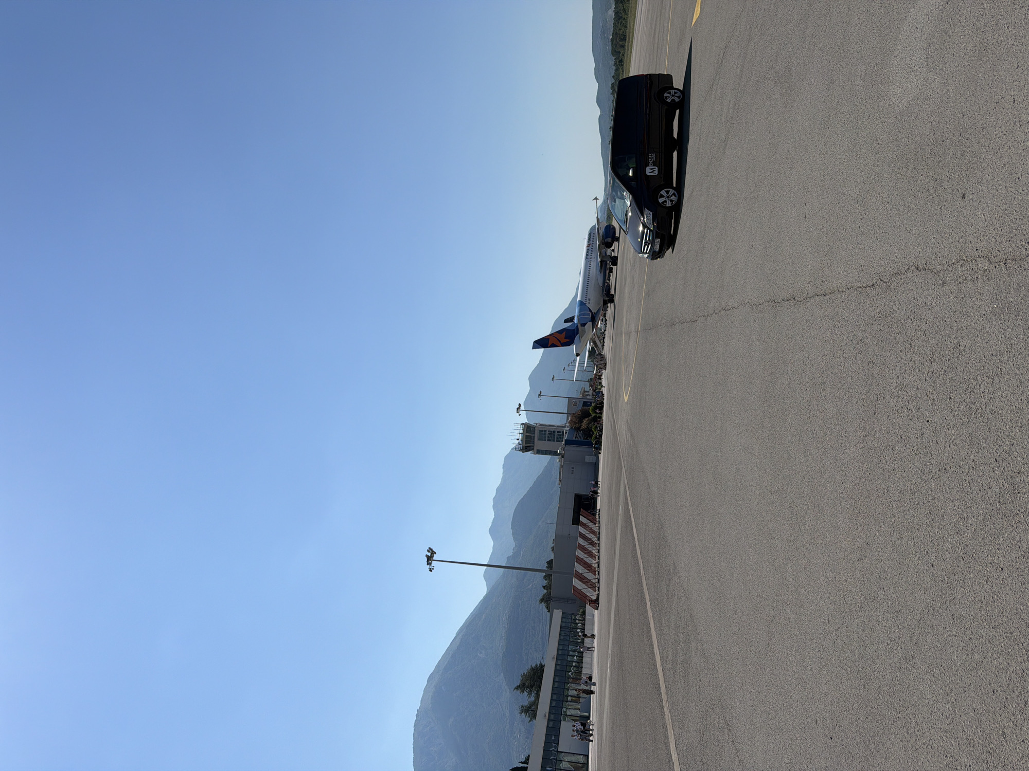 Departure day: tarmac, water views, and a yacht outside