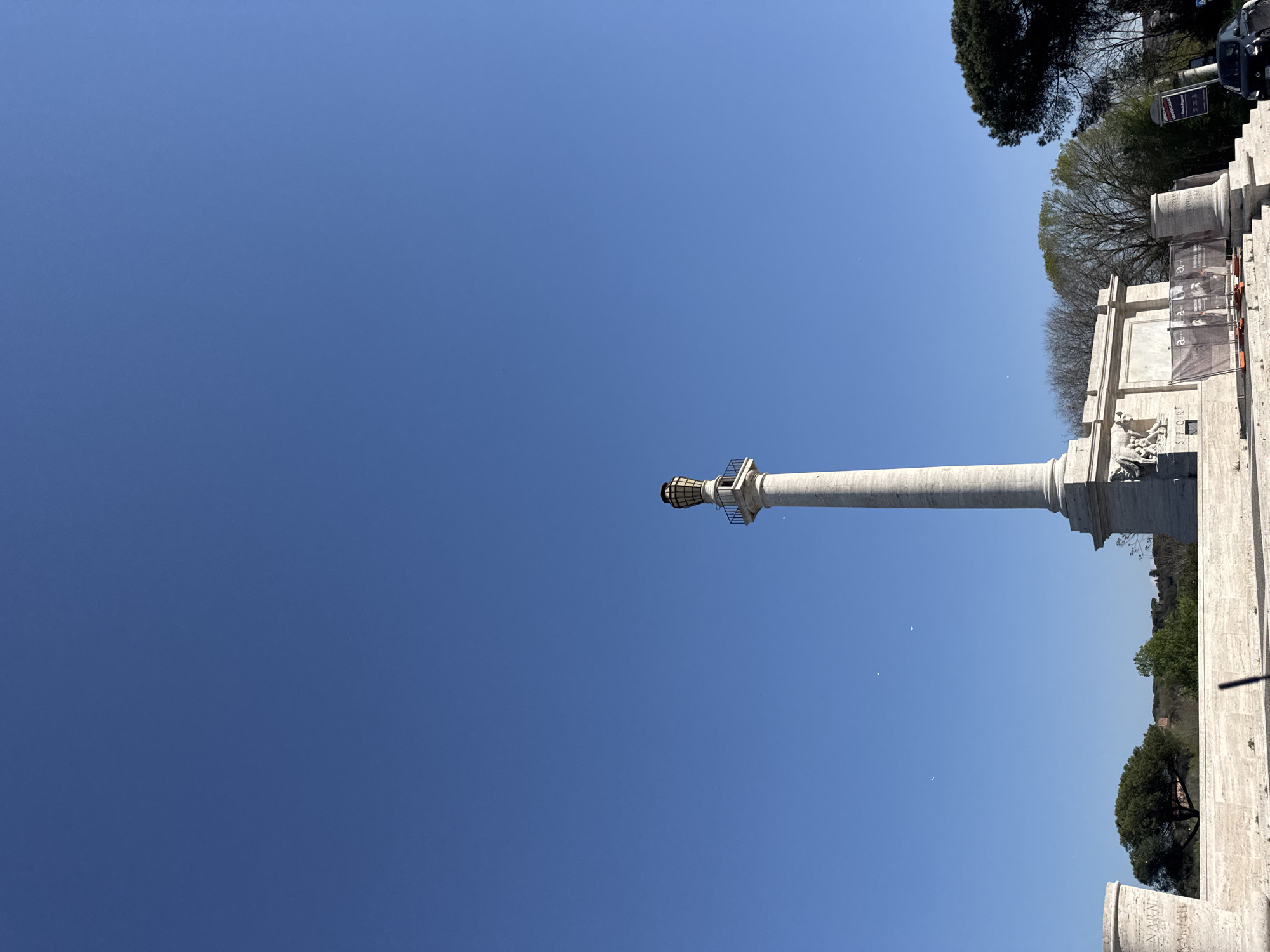 Tourist photographs historic Marcus Aurelius Column in Rome