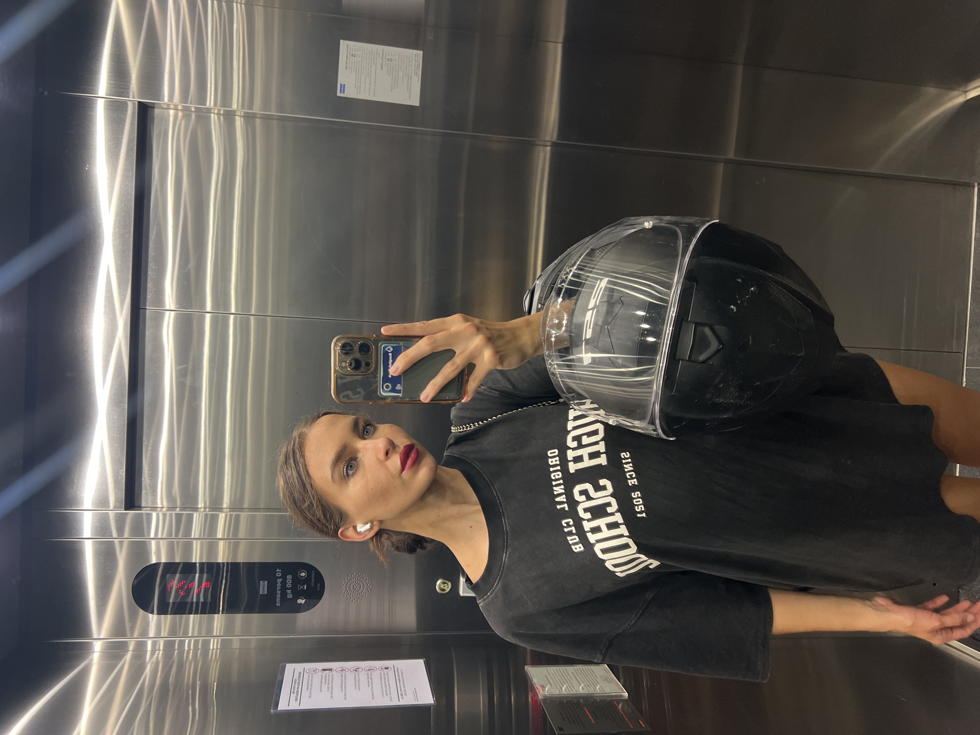 Woman takes selfies with motorcycle helmet in Wichit building