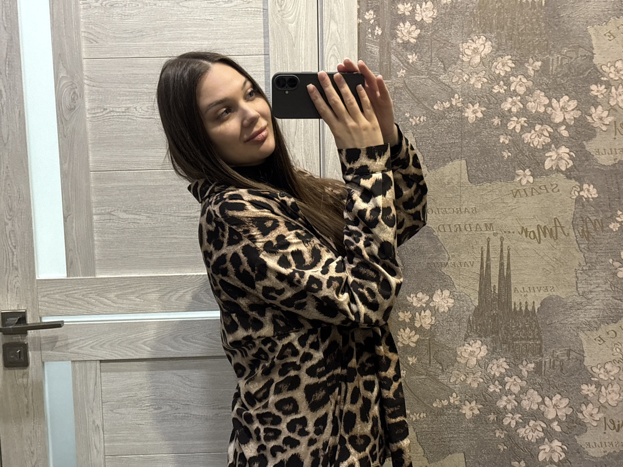 Woman takes selfies with Yekaterinburg city lights backdrop