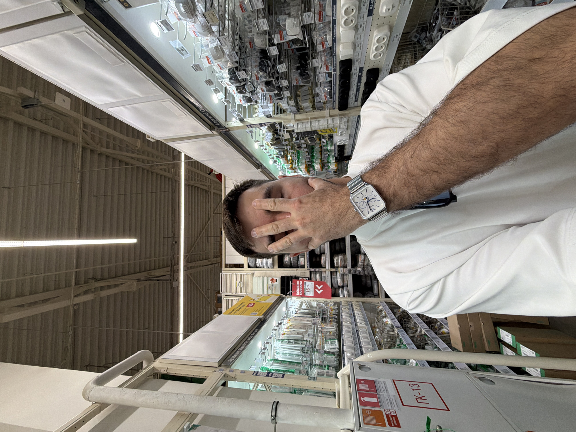 Man covers face in Krasnoyarsk electronics store
