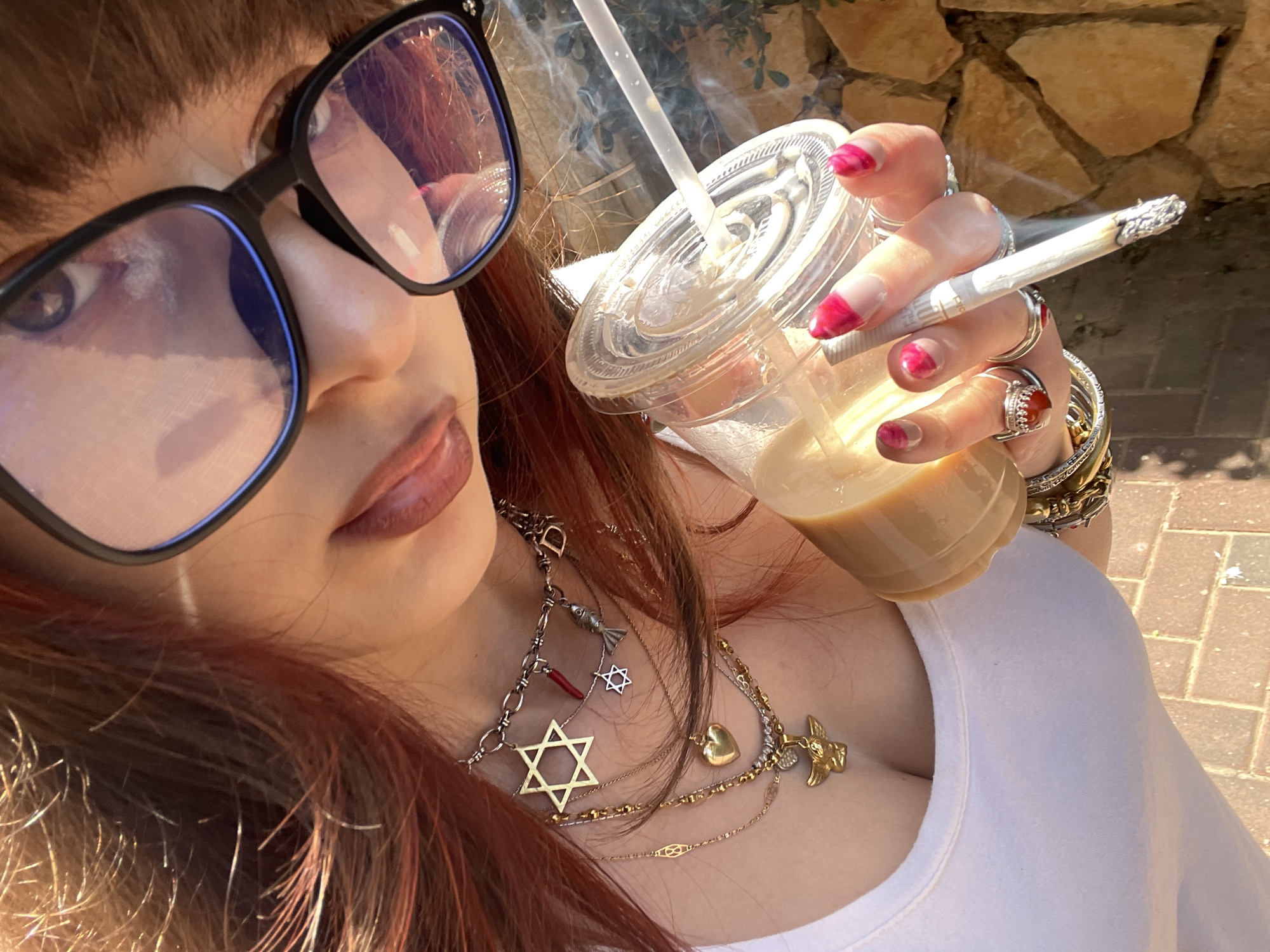 Woman Takes Selfies With Coffee on Raanana Street