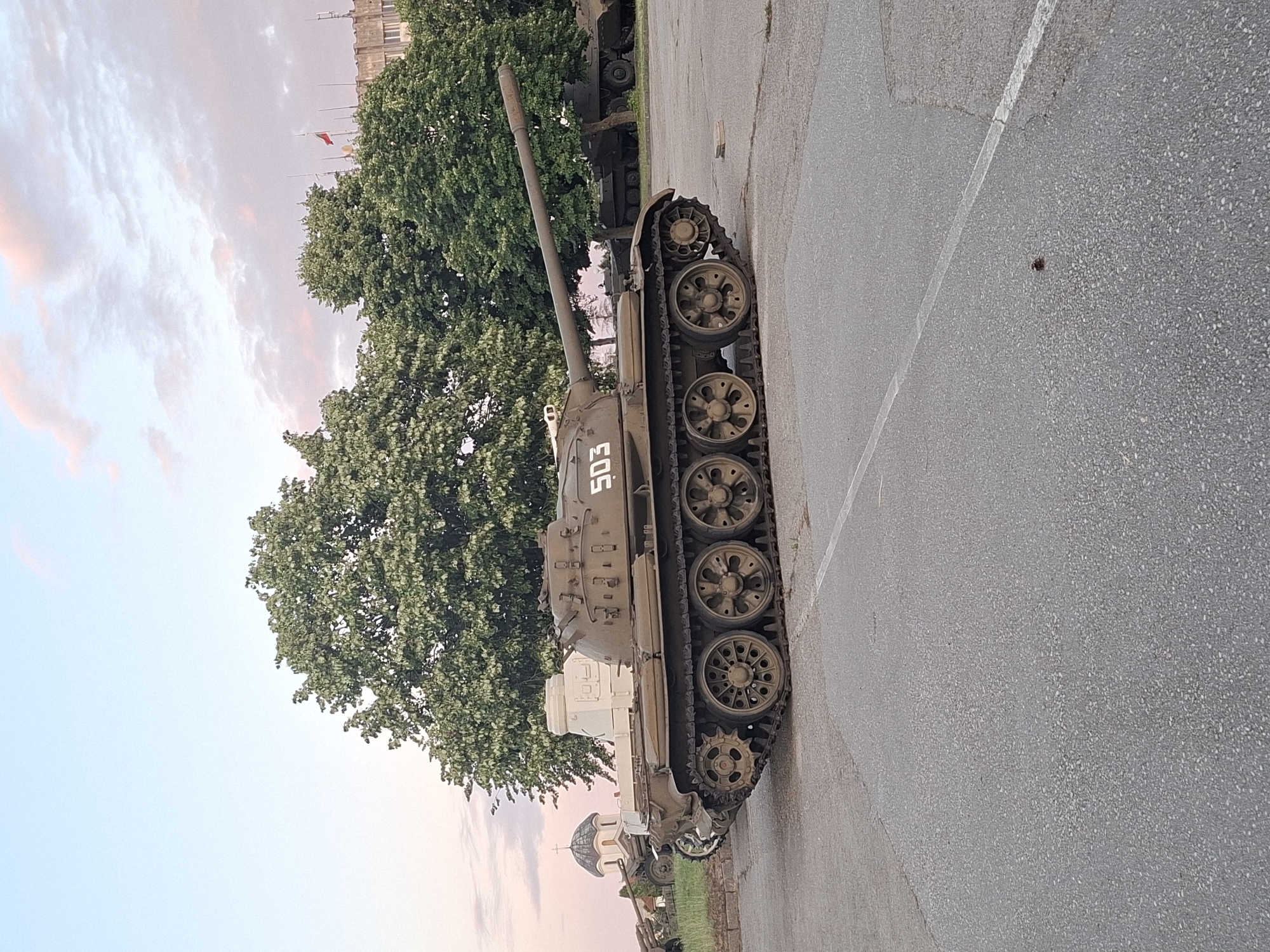 Tanks, monuments, and dusk light at a military compound