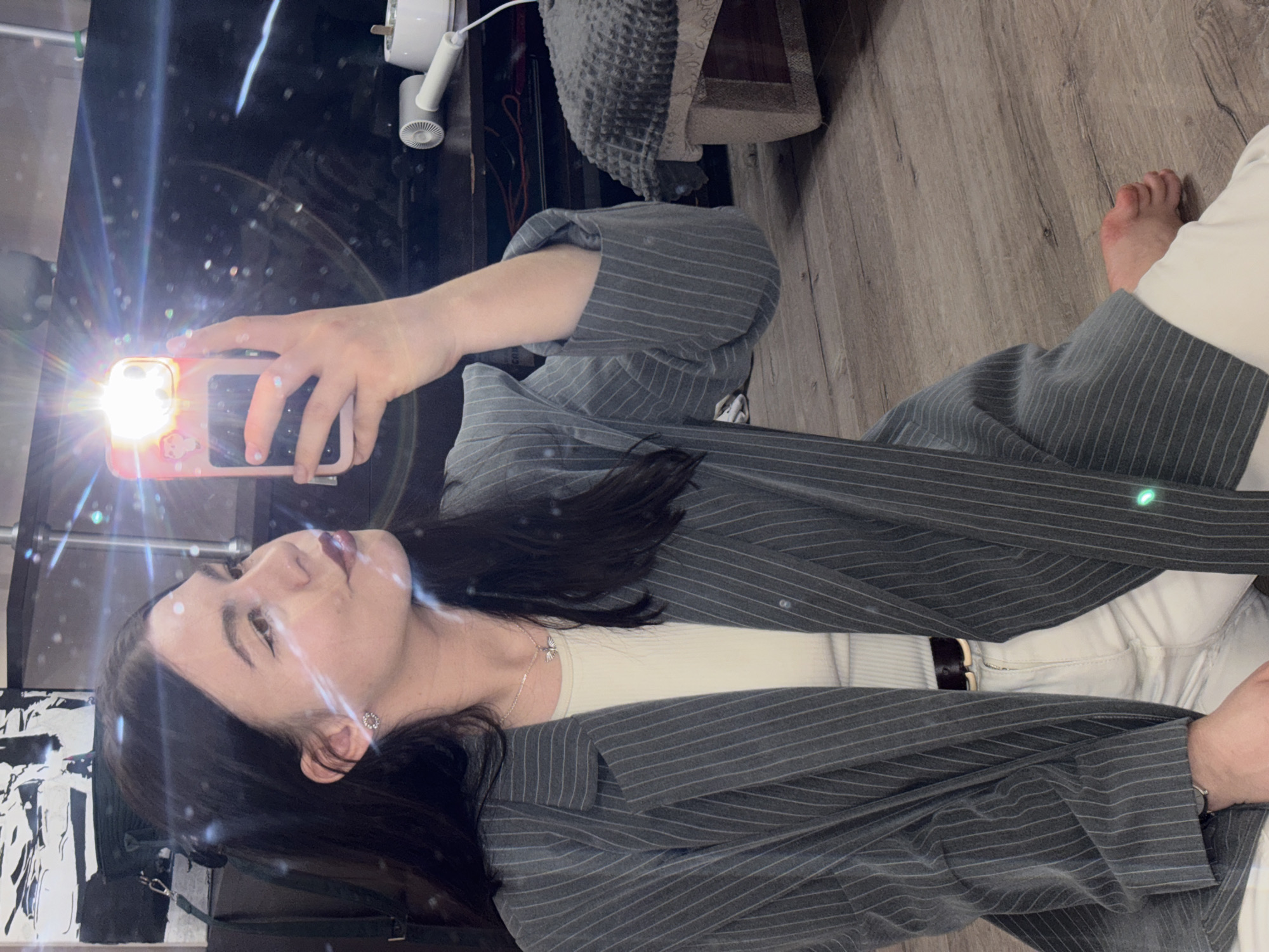 Woman takes mirror selfie in business attire in Perm