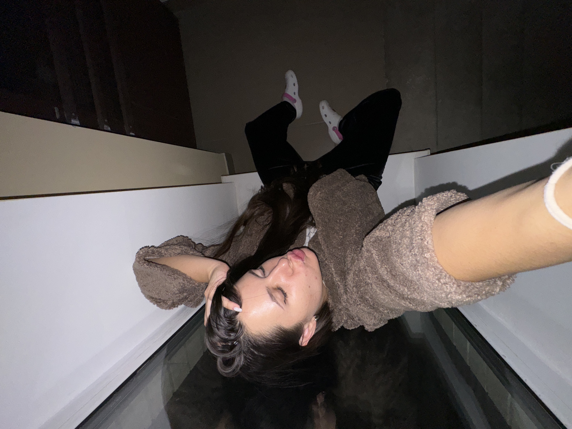 Woman photographed in brown sweater across Moscow-area buildings