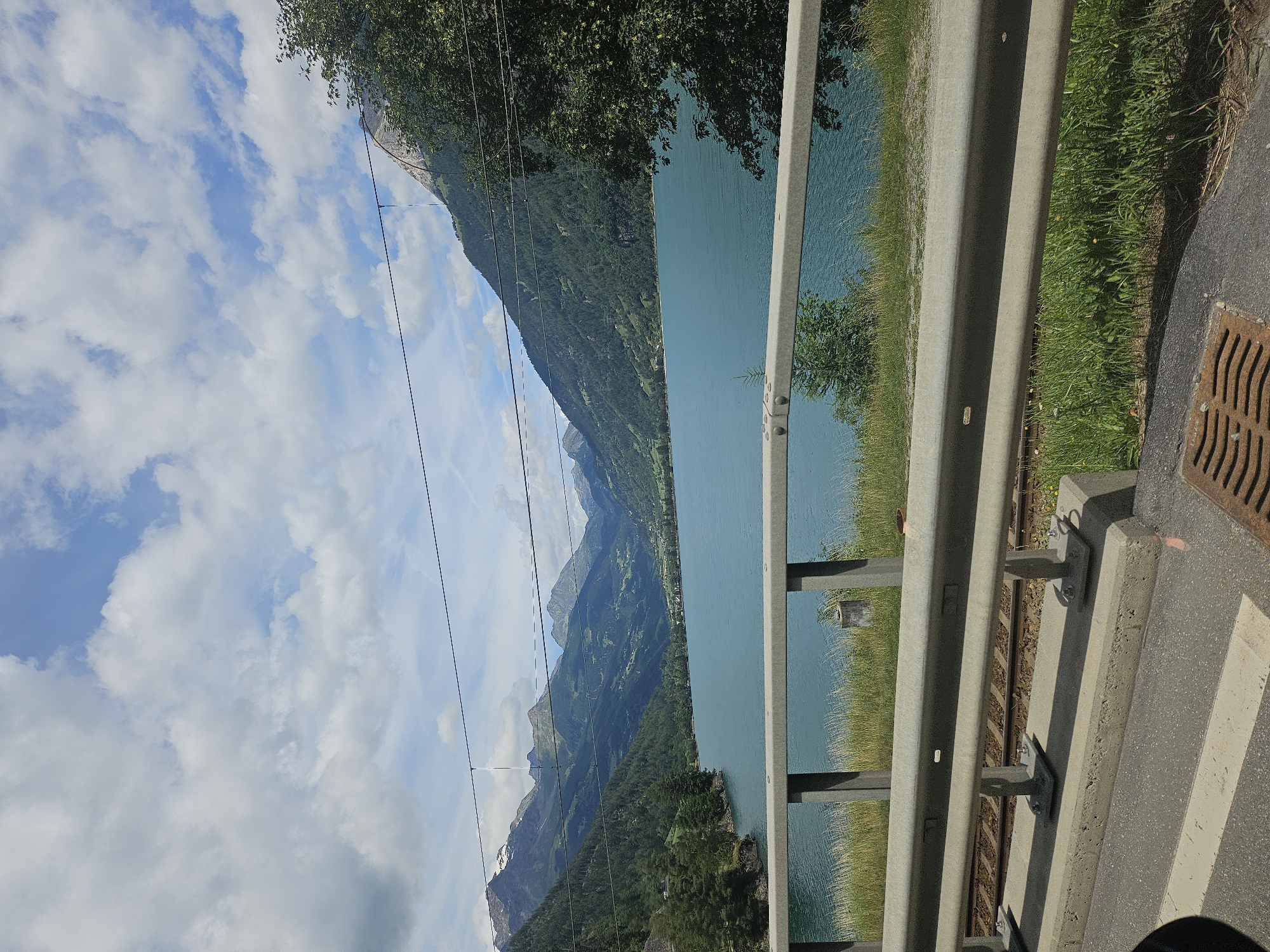 Trackside views of a turquoise alpine lake in Le Prese