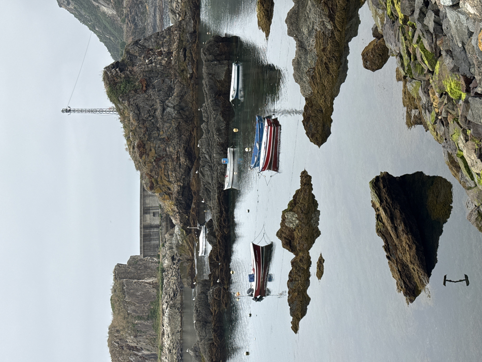 Cudillero's harbor, tunnels, and waterfall on a quiet morning