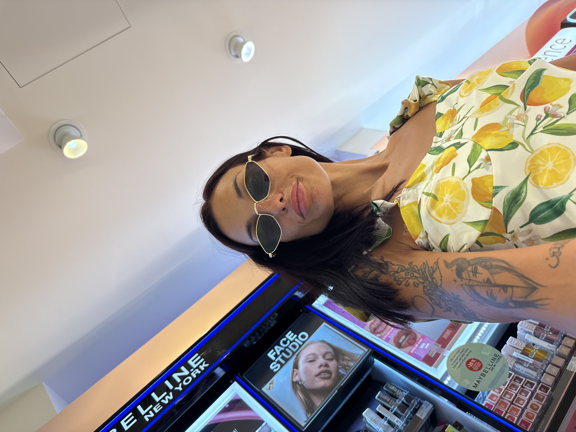 Selfie in a Pleven cosmetics store, lemon dress and cat-eye shades