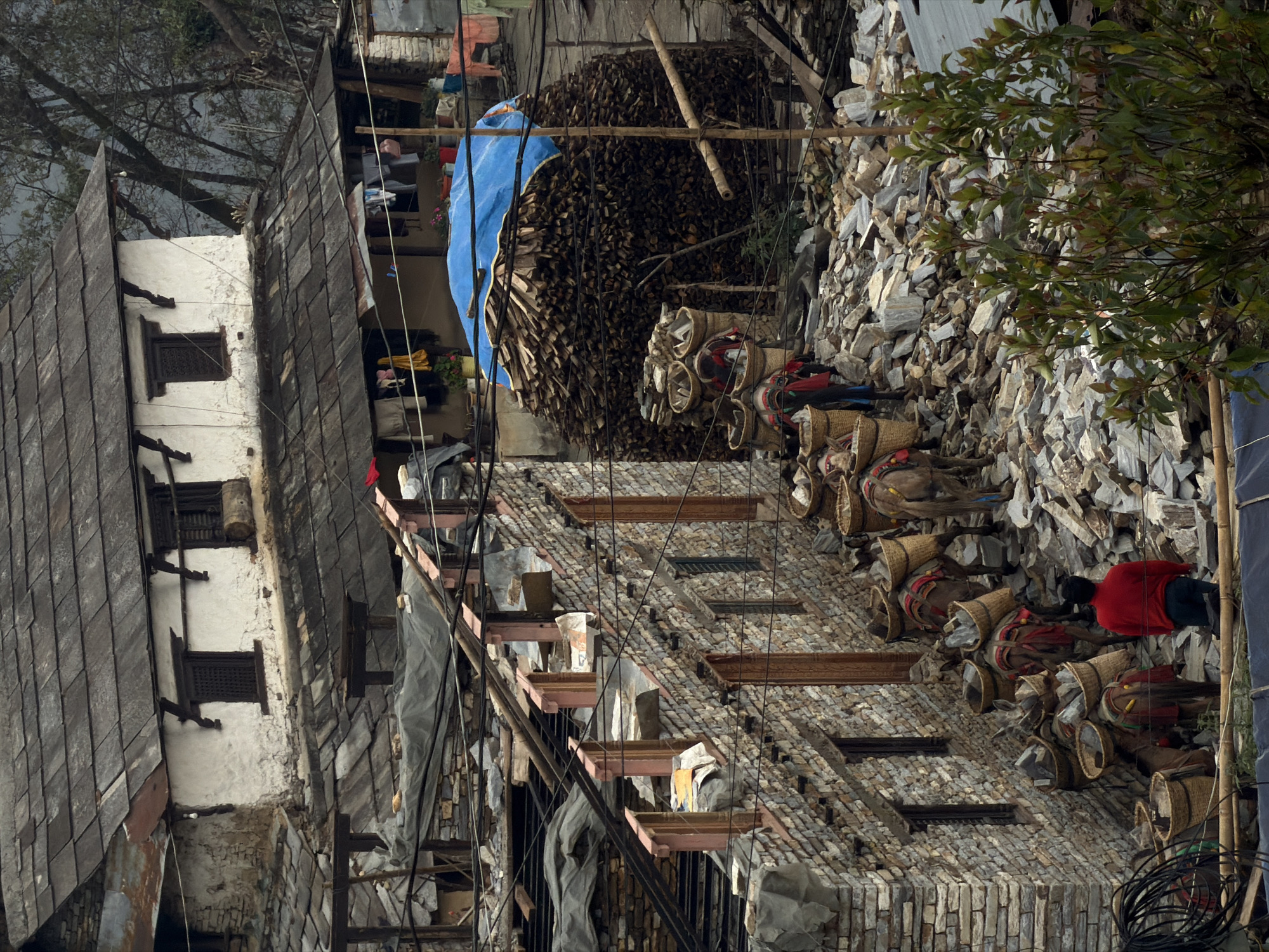 Tourist documents traditional village life in Purano Ghandruk, Nepal