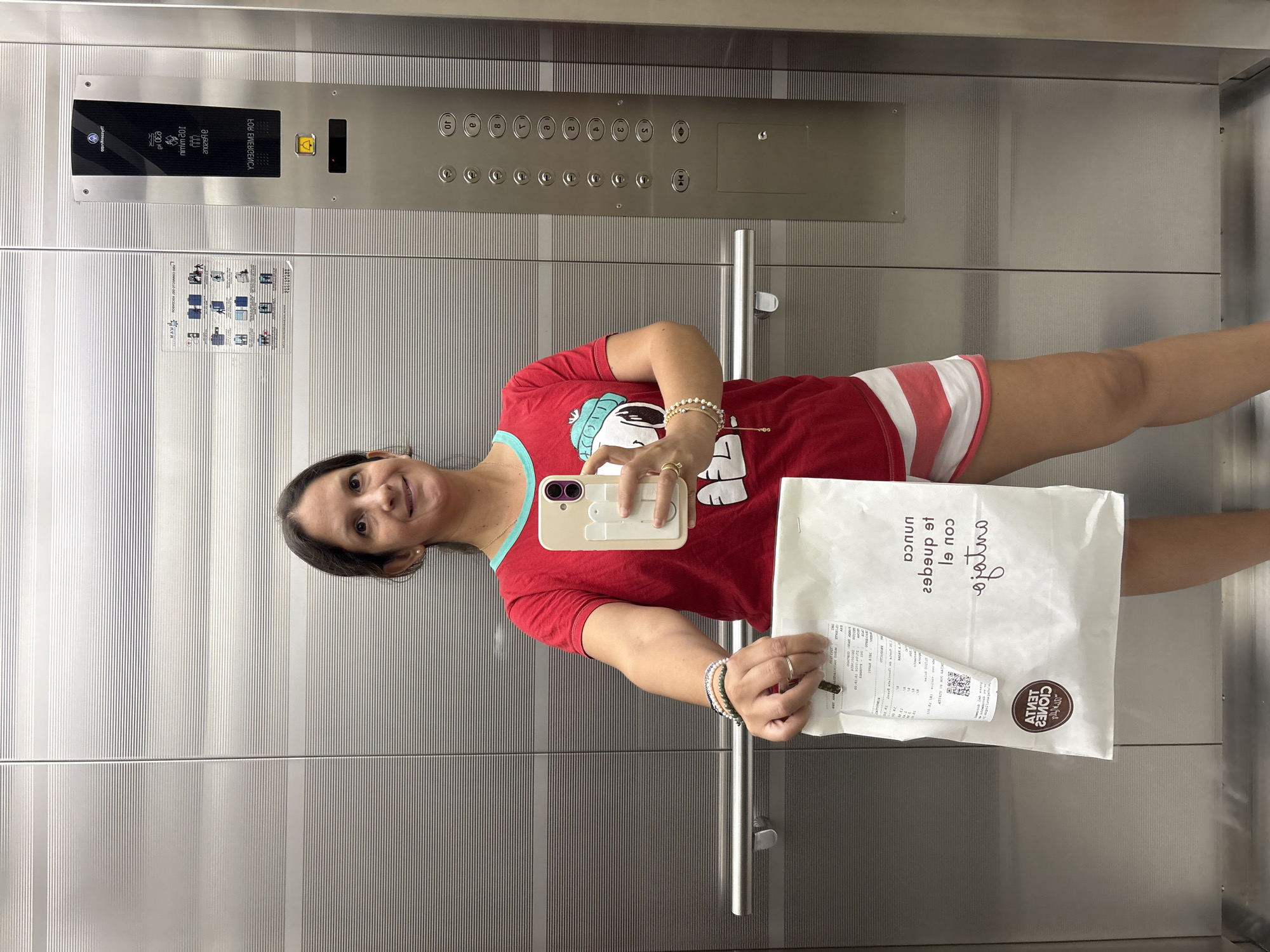 Woman Takes Mirror Selfie in Modern Elevator in Lima