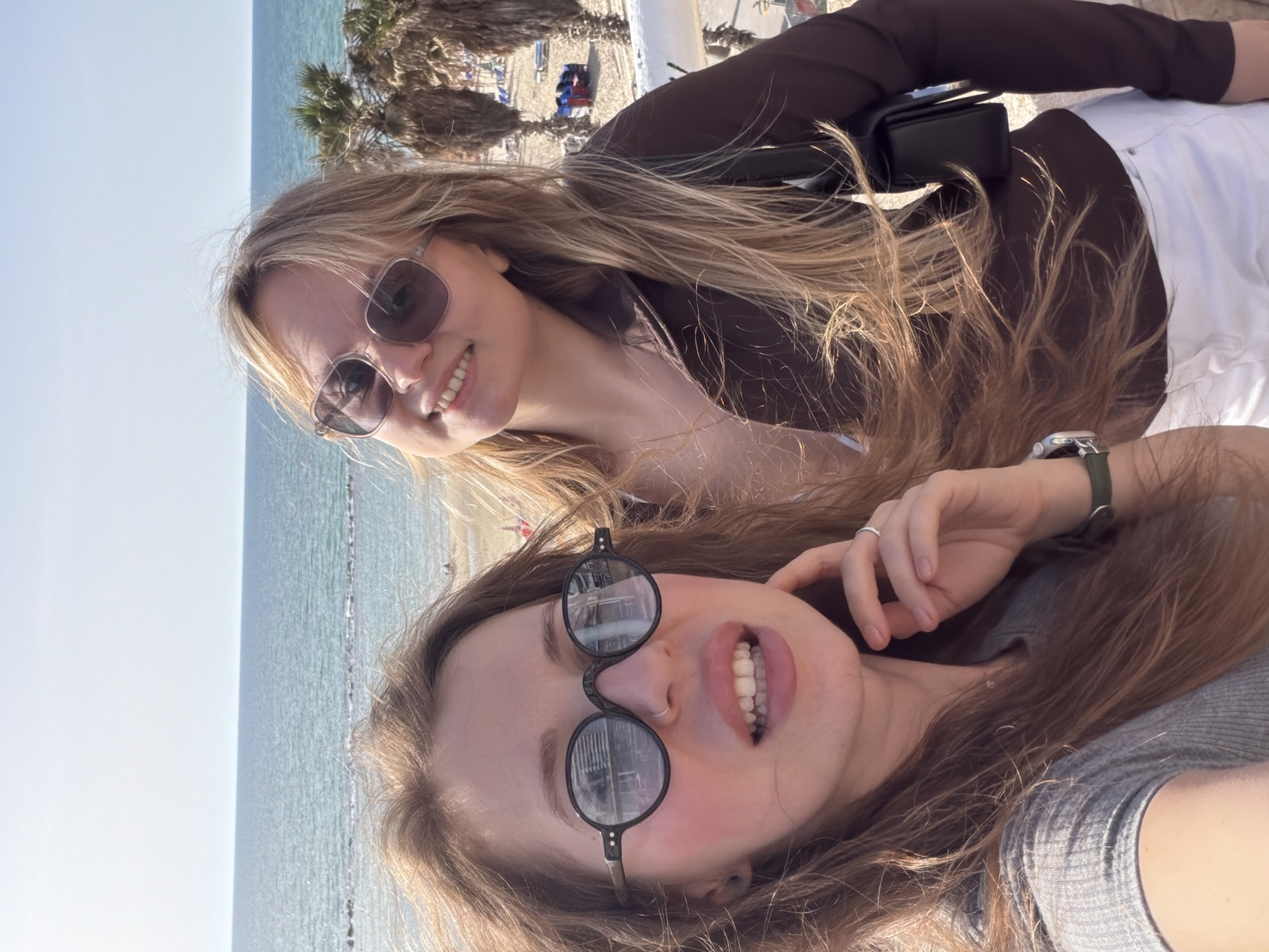 Women take beachside selfies on Bat Yam balcony