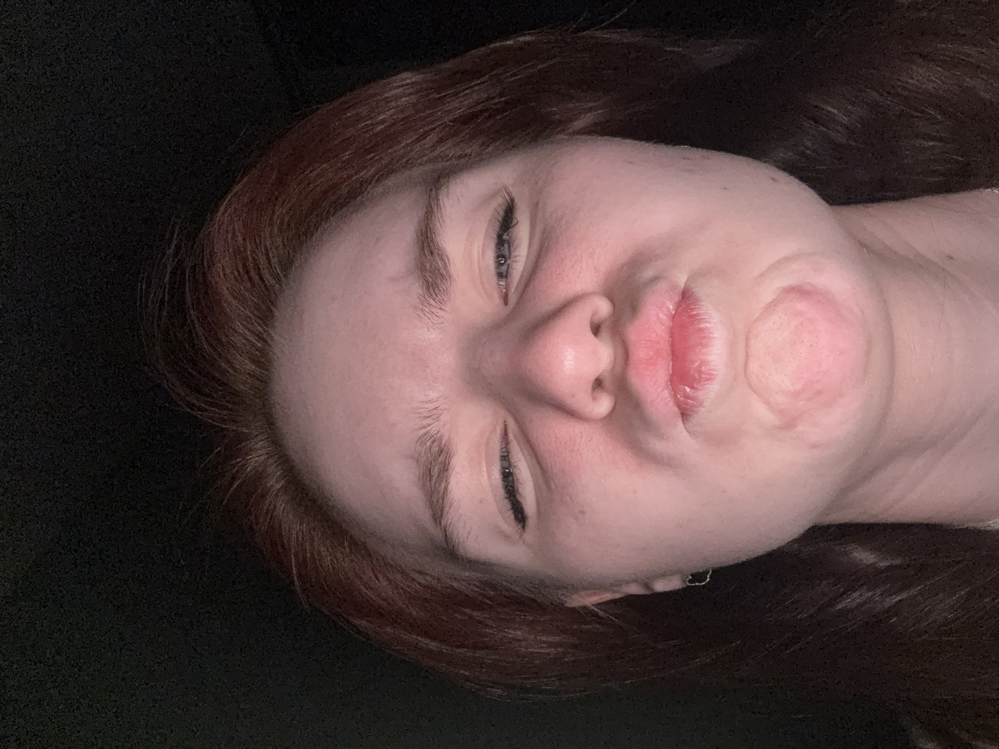 Person takes selfie with puckered lips expression
