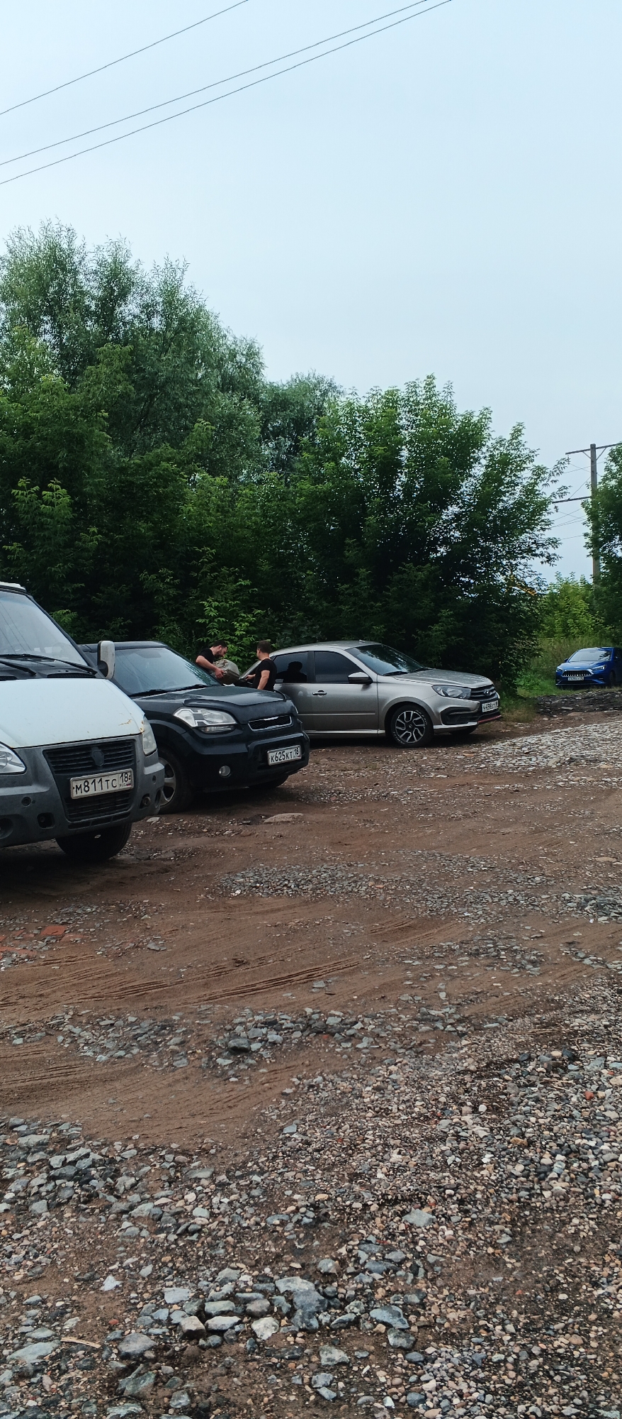 Rainy summer afternoon on a rough road through Pirogovo