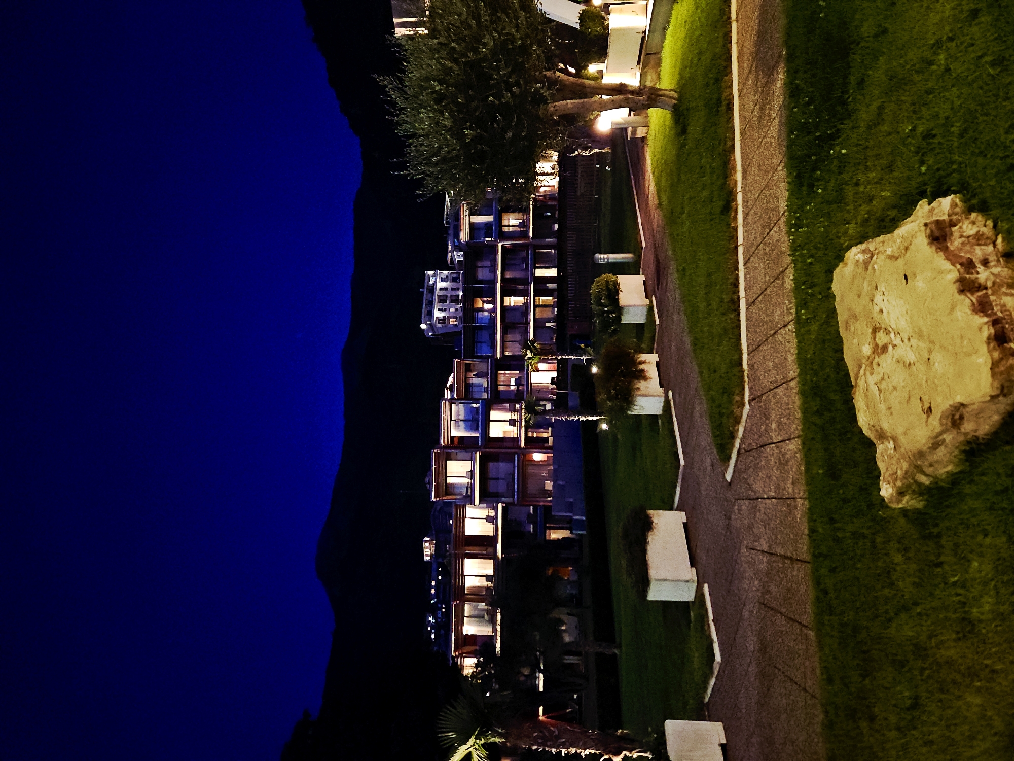 Waterfront resort evening with dining, live music, and bay views