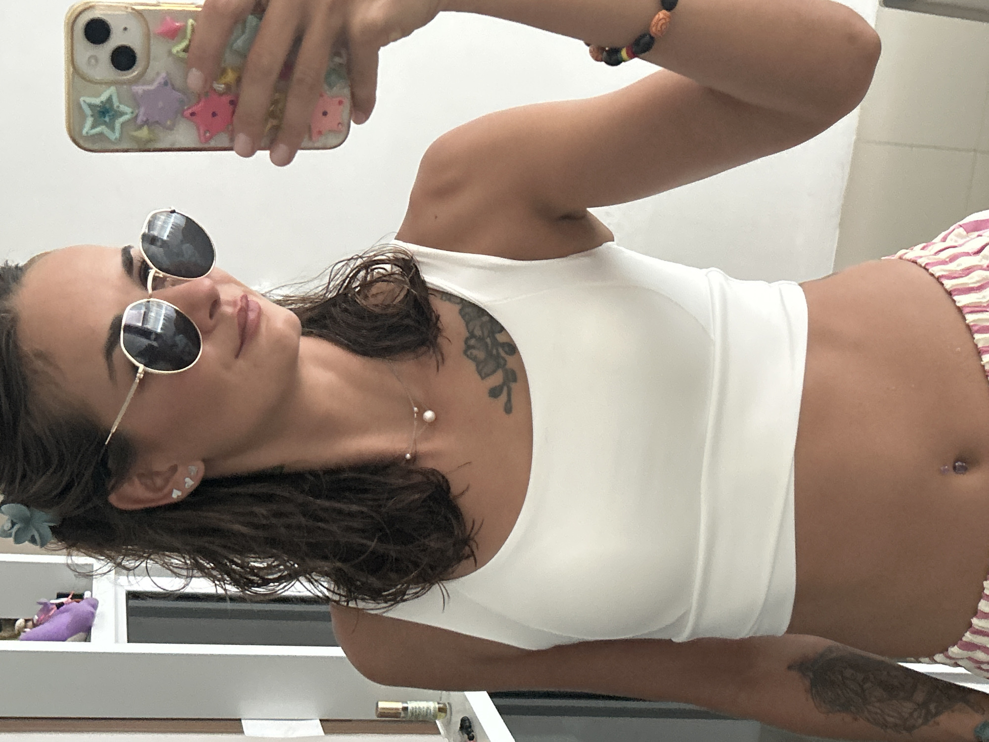 Woman takes mirror selfie indoors in Kathu, Thailand