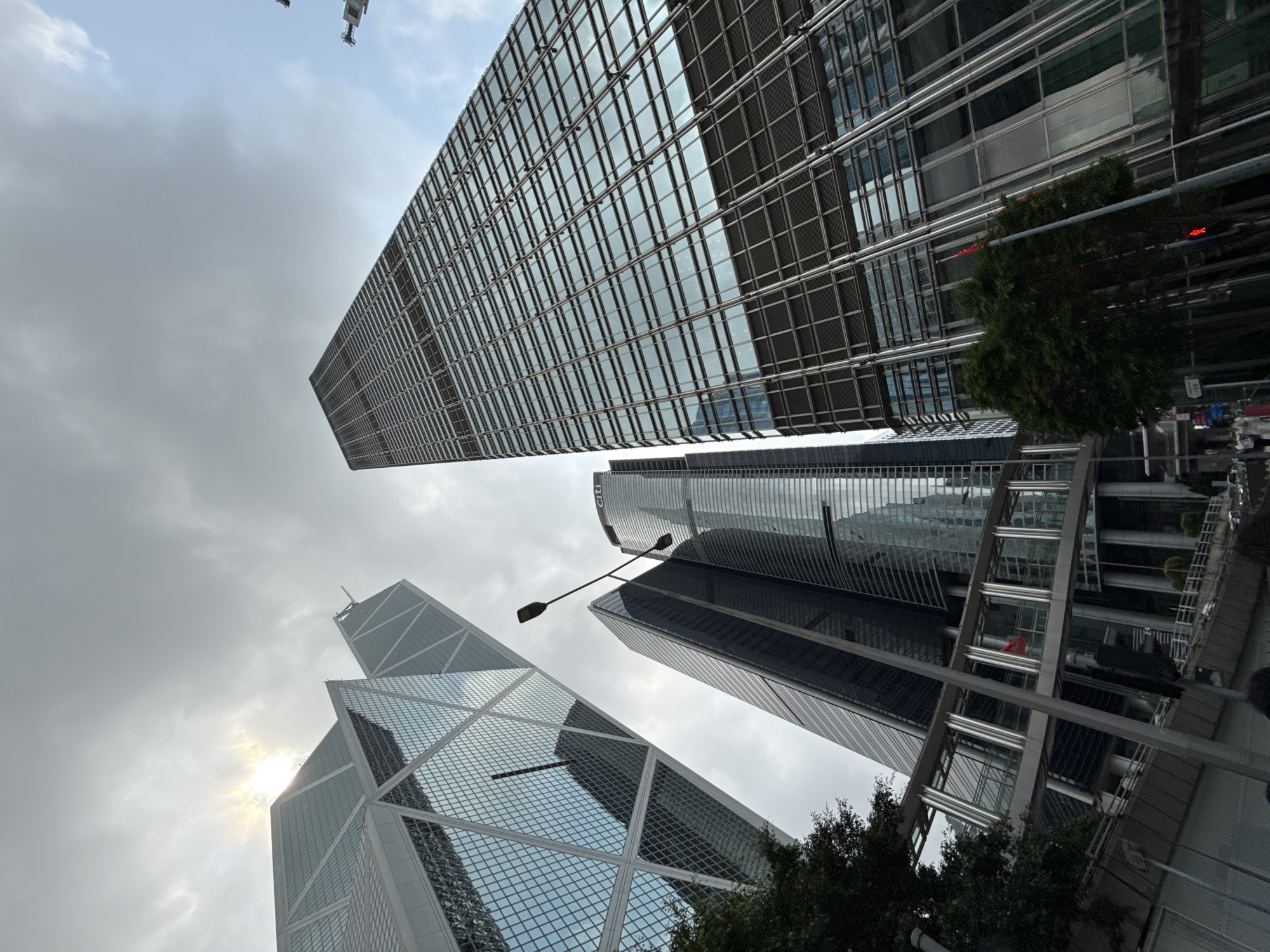 Street-level documentation captures Central Hong Kong skyscrapers and parked Porsche