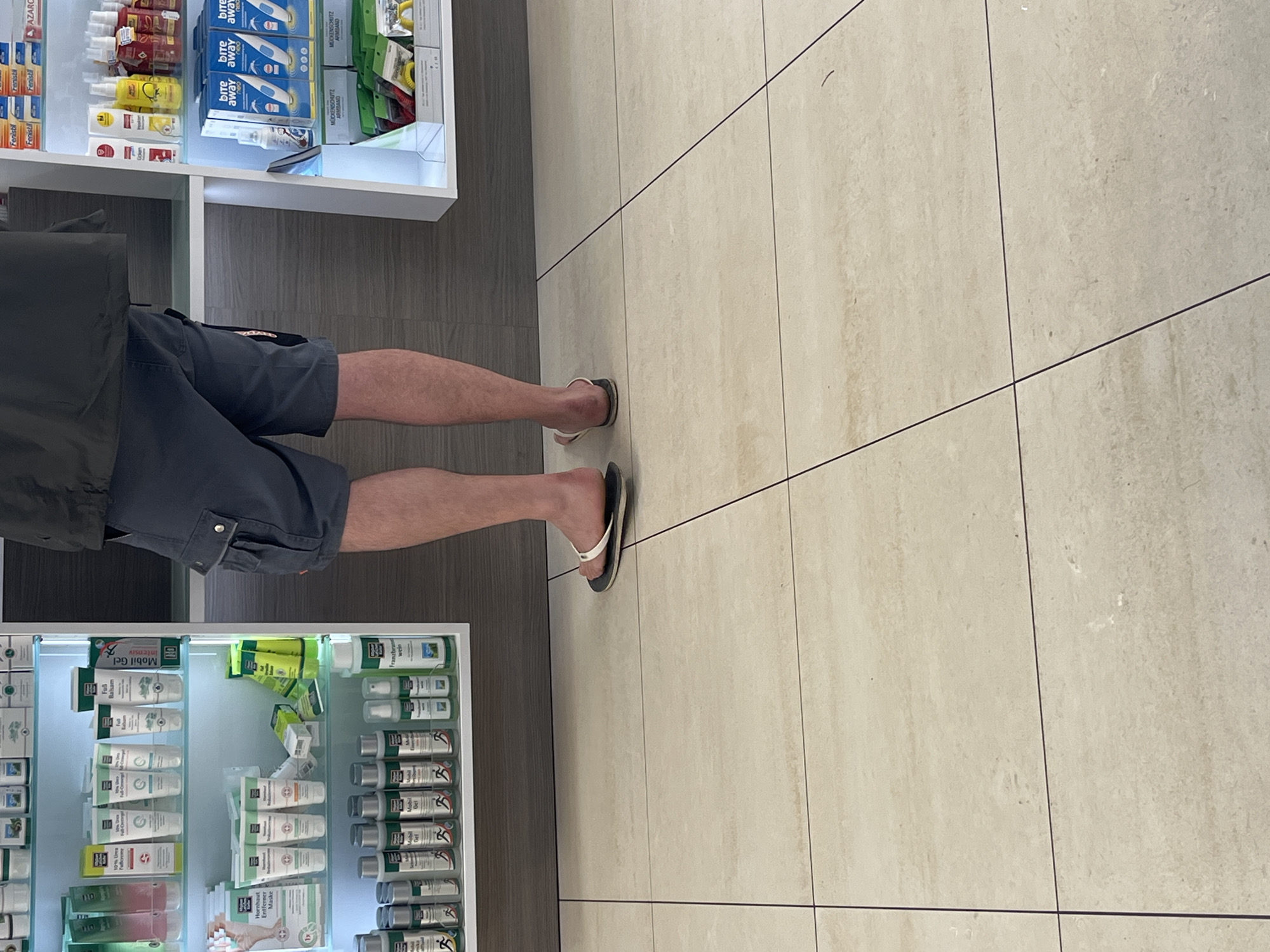 Person visits pharmacy in Saarbrücken wearing casual summer attire