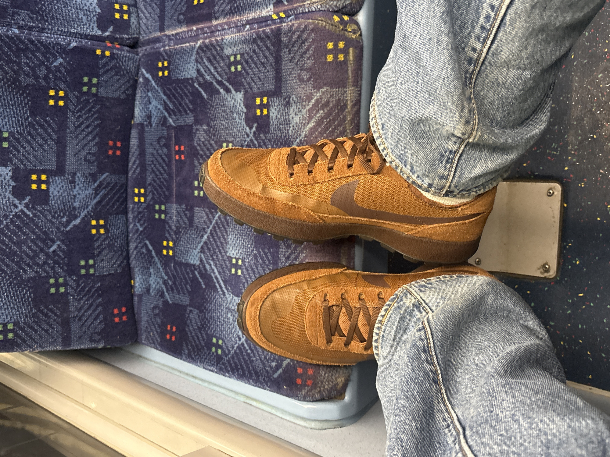 Train passenger in Nike shoes documented on London transit