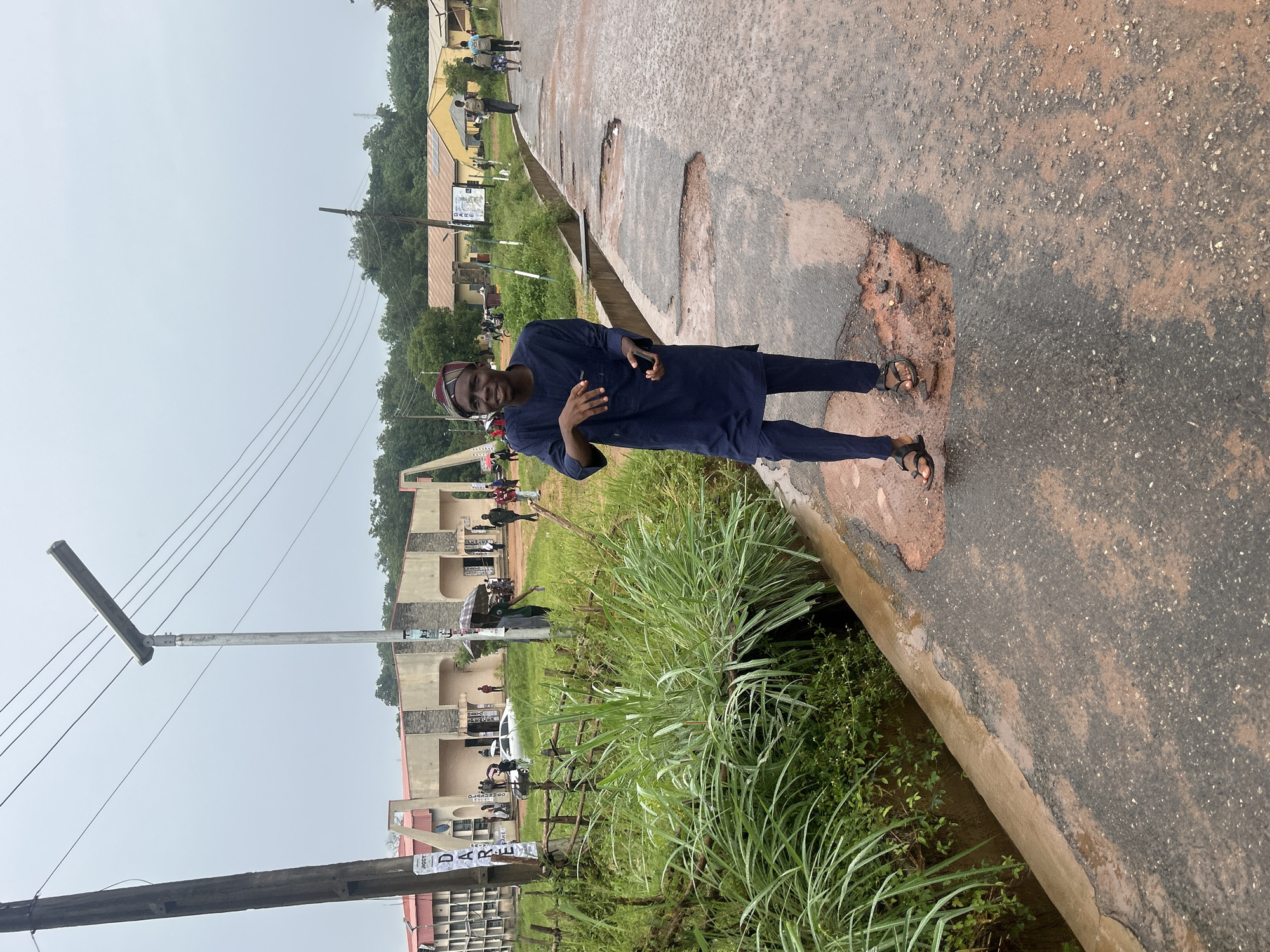 Pothole-riddled street scene in rainy Ogbomosho, Nigeria