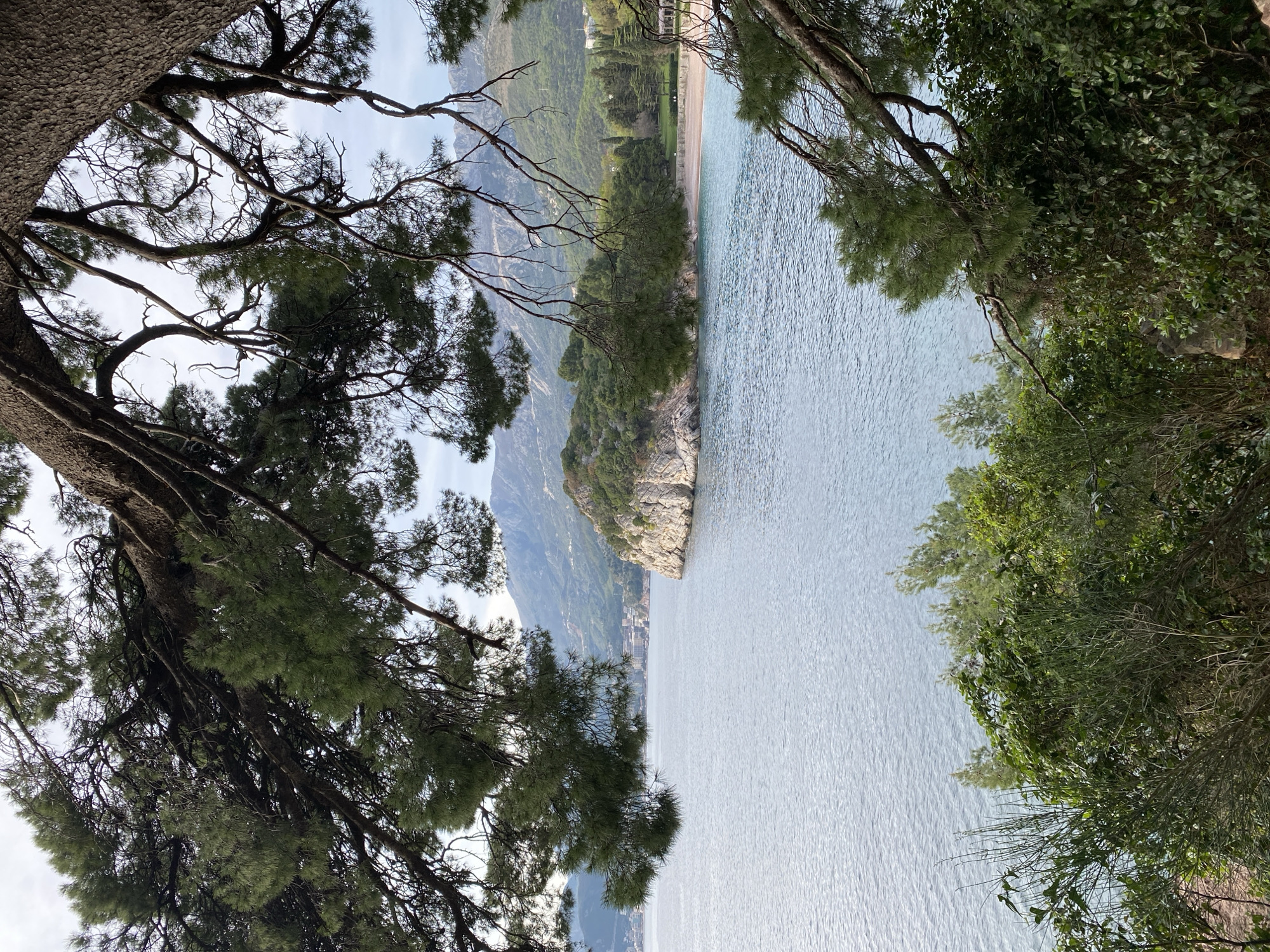 Tourist documents scenic views of Sveti Stefan resort Montenegro