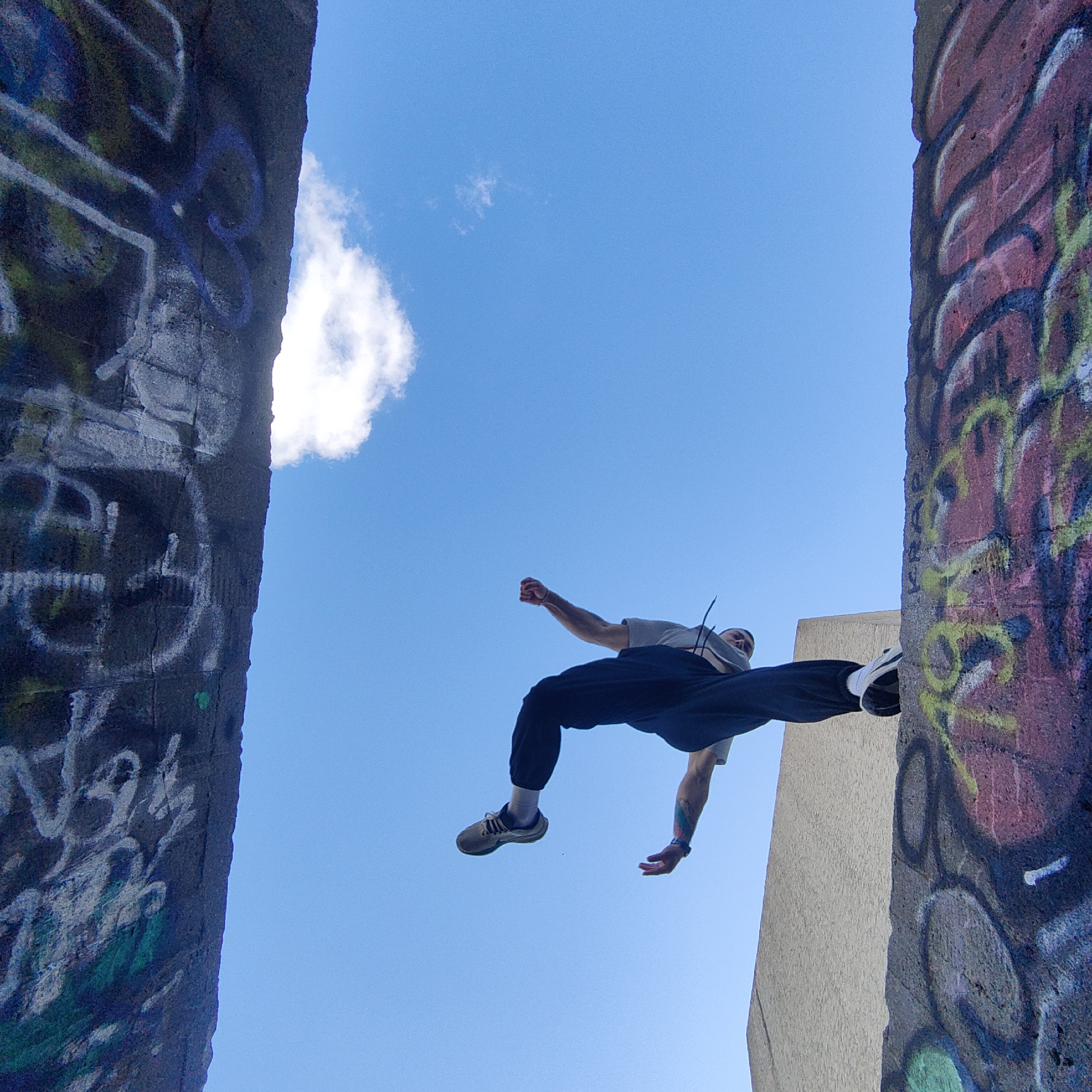 Parkour enthusiast jumps between concrete structures in Varna