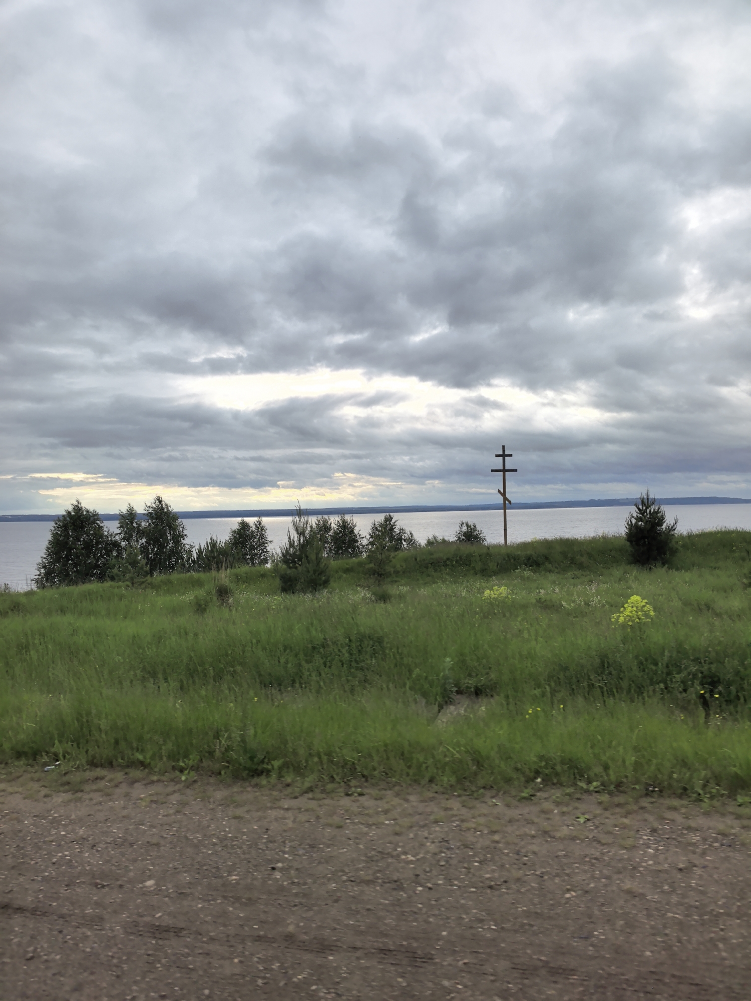 Rural dirt road documented under overcast skies
